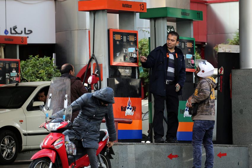 Iranians fill their vehicles at a petrol station in Tehran, on November 15, 2019. - Iran imposed petrol rationing and raised pump prices by 50 percent or more today, in a new move to cut costly subsidies that have fuelled high consumption and rampant smuggling. The Islamic republic provides some of the most heavily subsidised petrol in the world, with the pump price previously standing at just 10,000 rials (less than nine US cents) a litre. (Photo by STR / AFP)