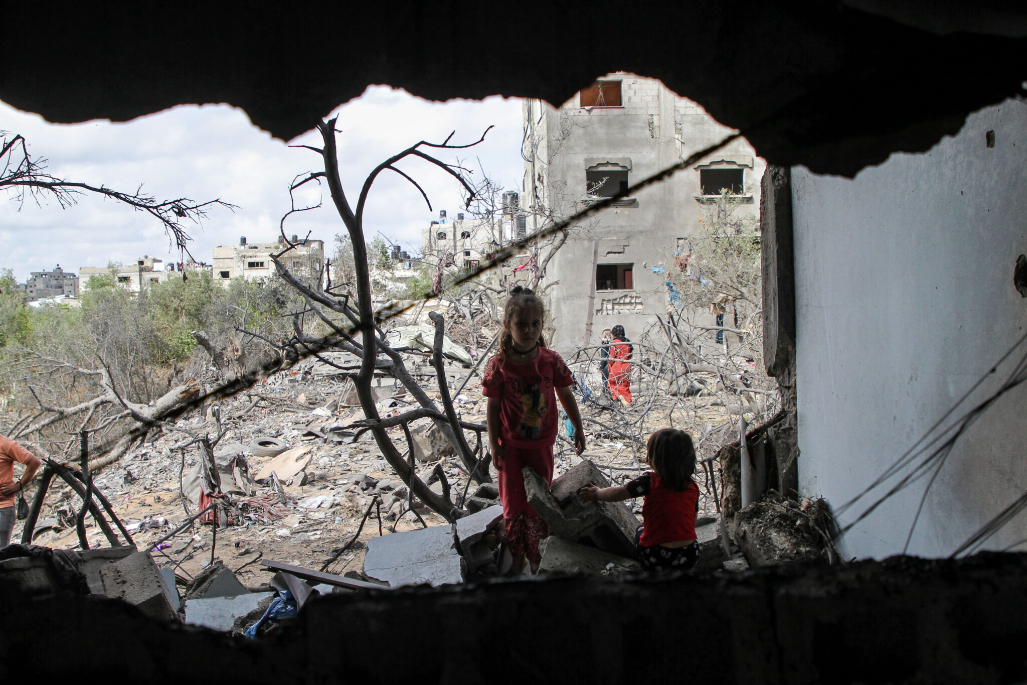 (210521) -- GAZA, May 21, 2021 (Xinhua) -- Palestinian children are seen at their house destroyed in an Israeli air strike, after the ceasefire between Israel and Hamas, in the northern Gaza Strip town of Beit Lahia, on May 21, 2021. An Egyptian-brokered ceasefire agreement came into effect early on Friday between Israel and Hamas, which rules the Gaza Strip, ending the 11-day bloodshed. Fighting between Israel and the Hamas-led militant groups in the Gaza Strip has left more than 100 people dead and tens of thousands of people displaced. (Photo by Rizek Abdeljawad/Xinhua)