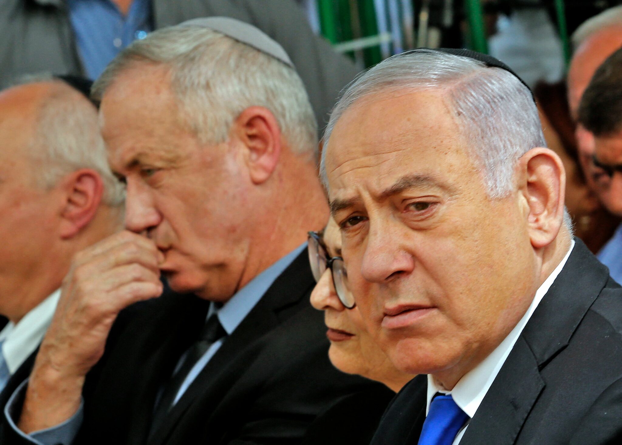 (FILES) In this file photo taken on September 19, 2019 Israeli Prime Minister Benjamin Netanyahu (R), Israeli president of the Supreme Court Esther Hayut (C) and Benny Gantz (L), leader of Blue and White party, attend a memorial ceremony for late Israeli president Shimon Peres, at Mount Herzl in Jerusalem. Benjamin Netanyahu, who appeared closer than ever to leaving office as a coalition of rivals said they had formed a government, is Israel's longest-serving prime minister. The wily 71-year-old, widely known as Bibi, has clung to a record 12 years in power through several conflicts and a long period of political turmoil, despite also facing trial for alleged fraud, bribery and breach of trust -- charges he denies. / AFP / GIL COHEN-MAGEN