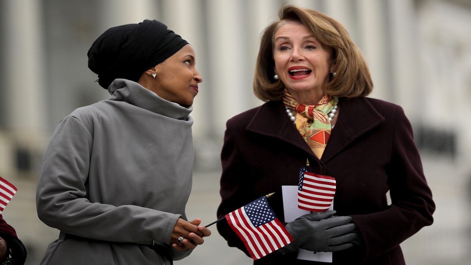 WASHINGTON, DC - MARCH 08: Rep. Ilhan Omar (D-MN) (L) talks with Speaker of the House Nancy Pelosi (D-CA) during a rally with fellow Democrats before voting on H.R. 1, or the People Act, on the East Steps of the U.S. Capitol March 08, 2019 in Washington, DC. With almost zero chance of passing the Senate, H.R. 1 is a package of legislation aimed at bolstering voting rights, reducing corruption in Washington and overhauling the campaign finance system in an effort to reduce the influence of 'special interests.' (Photo by Chip Somodevilla/Getty Images)