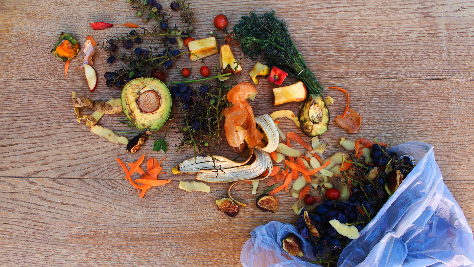 Domestic waste for compost from fruits and vegetables in the garbage bag on the table.