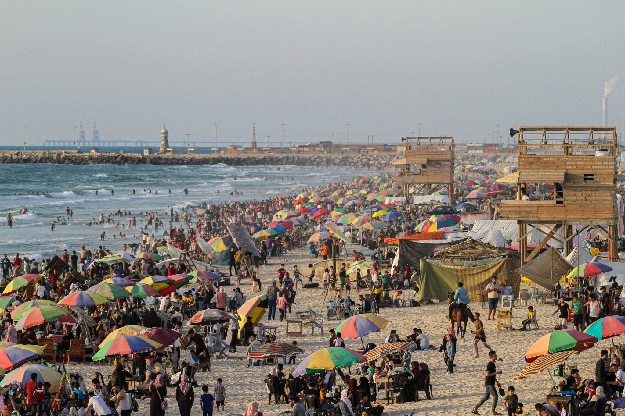 (210612) -- GAZA, June 12, 2021 (Xinhua) -- Palestinians enjoy themselves in the Mediterranean Sea off Gaza coast in Gaza City, on June 11, 2021. (Photo by Rizek Abdeljawad/Xinhua)