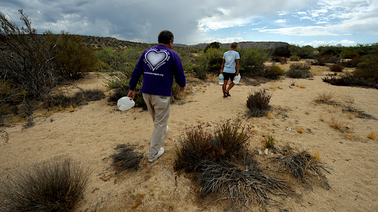 This photo taken on on August 21, 2014, shows volunteers from the group "Border Angels" placing water bottles to help illegal immigrants as they cross the US-Mexico border at Jacumba, California. Every year, thousands of would-be immigrants steal across the border and over the years thousands have died in the baking desert. "Border Angels" activists hide bottles of water in the desert along the border, where temperatures can reach 45 degrees Celsius. AFP PHOTO/Mark RALSTON (Photo credit should read MARK RALSTON/AFP/Getty Images)