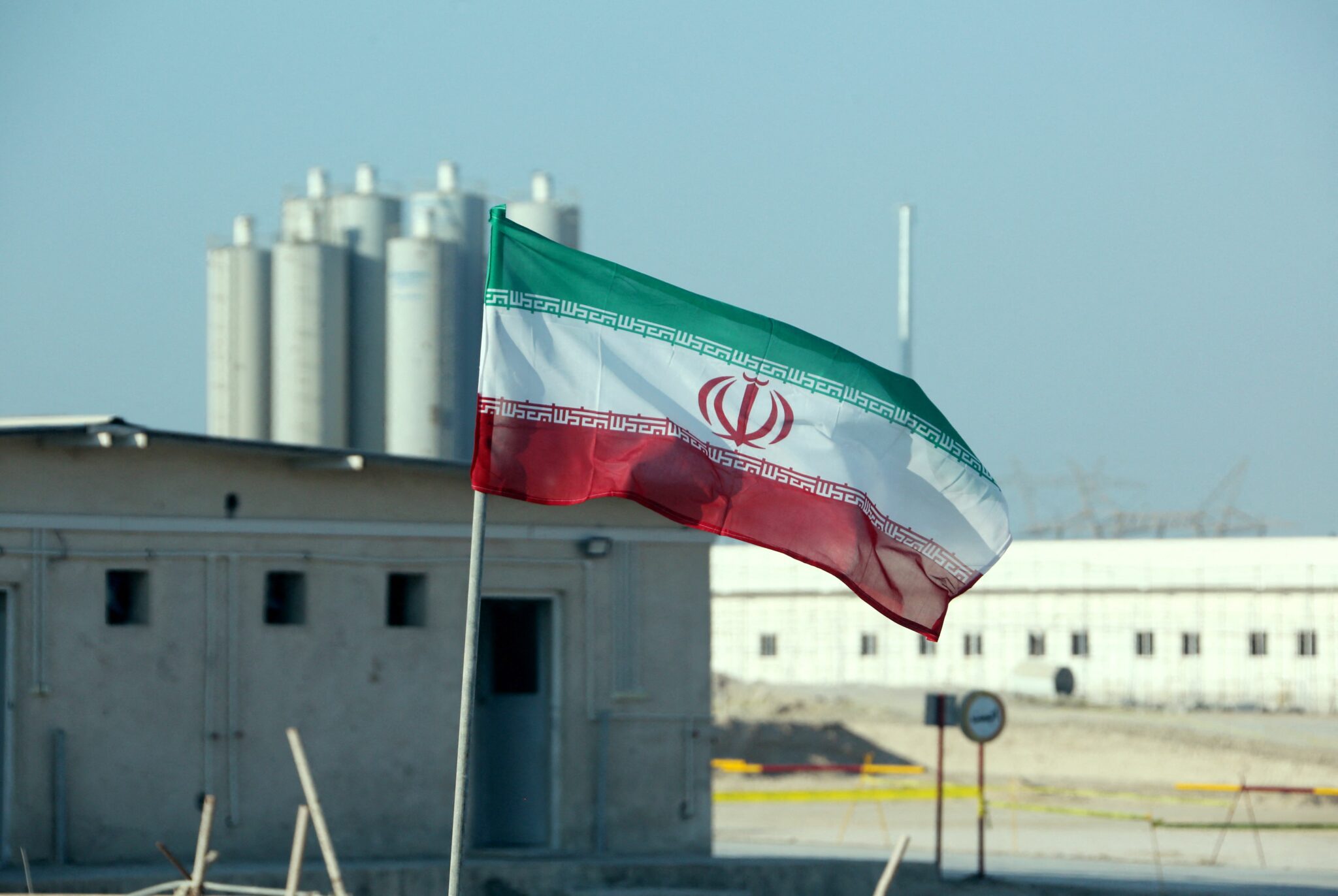 (FILES) This file photo taken on November 10, 2019, shows an Iranian flag in Iran's Bushehr nuclear power plant, during an official ceremony to kick-start works on a second reactor at the facility. The United States and European powers on July 6, 2021 warned Iran that its latest uranium enrichment efforts could imperil the nuclear talks in Vienna, with Washington calling on Tehran to halt its "brinksmanship." / AFP / ATTA KENARE