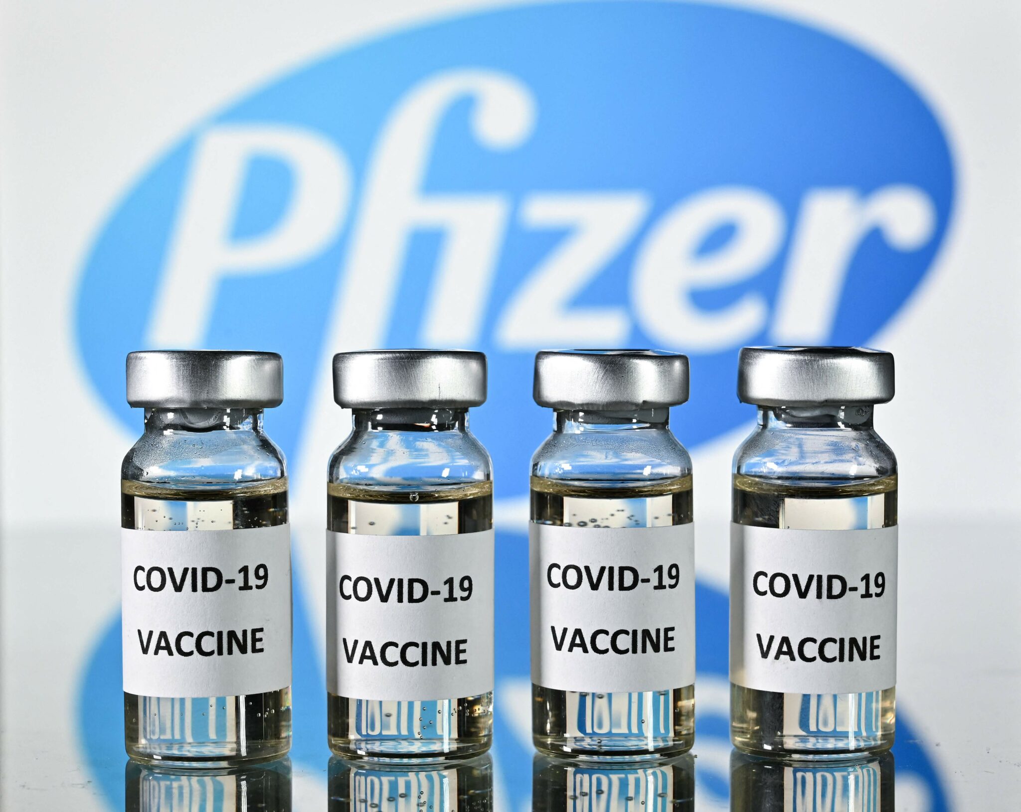 (FILES) This file photo illustration picture shows vials with Covid-19 Vaccine stickers attached, with the logo of US pharmaceutical company Pfizer, on November 17, 2020. Pfizer and BioNTech announced on July 8, 2021 they would seek regulatory authorization for a third dose of their Covid-19 vaccine. It comes after initial data from a trial showed a third shot pushed antibody levels five to 10 times higher against the original strain and the Beta variant compared to the first two doses alone, according to a statement / AFP / JUSTIN TALLIS