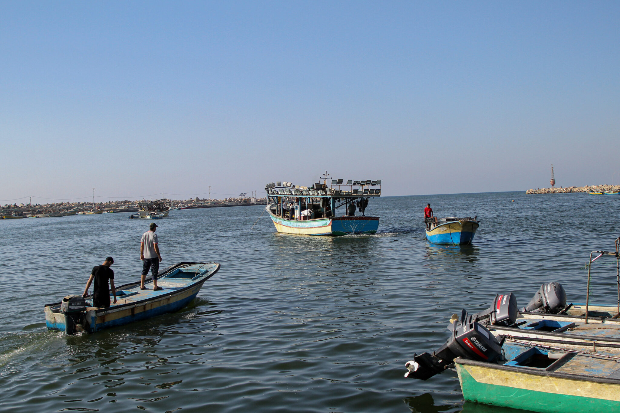 (210628) -- GAZA, June 28, 2021 (Xinhua) -- Fishermen go fishing off the Gaza Strip coast, on June 28, 2021. In recent days, the Israeli authorities have eased some of the restrictions, including the opening of the only commercial crossing Kerem Shalom in the Gaza Strip. But the Palestinians in the enclave demand more. (Photo by Rizek Abdeljawad/Xinhua)TO GO WITH Roundup: Gazans demand easing more Israeli restrictions