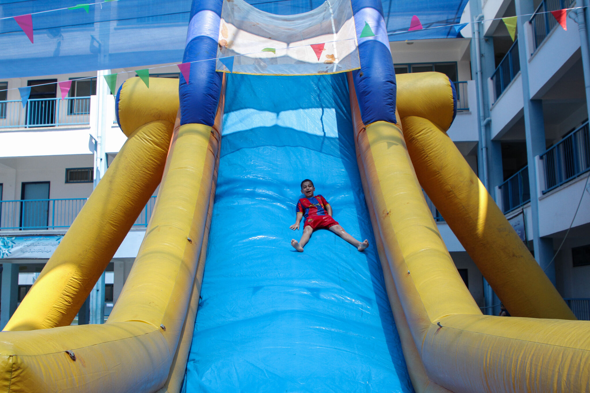 (210705) -- GAZA CITY, July 5, 2021 (Xinhua) -- A Palestinian boy plays during a summer camp organized by the United Nations Relief and Works Agency for Palestine Refugees in the Near East (UNRWA), in Gaza City, July 5, 2021. The UNRWA launched a four-week Summer Fun Weeks for Palestinian school children and registered refugee children throughout the Gaza Strip, offering a wide array of activities including sports, games, art and dance classes. (Photo by Rizek Abdeljawad/Xinhua)