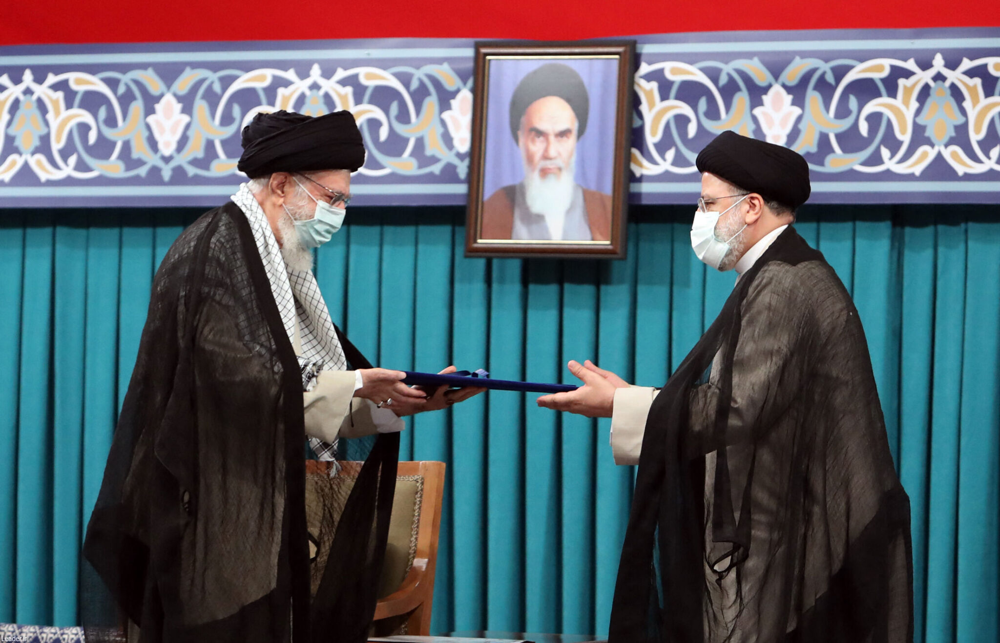 A handout picture provided by the office of Iran's Supreme Leader Ayatollah Ali Khamenei on August 3, 2021, shows him (L) during the inauguration ceremony for Ebrahim Raisi (R) as President, in Khamenei's office in the capital Tehran. Ultraconservative Raisi was inaugurated as president of Iran, a country whose hopes of shaking off a dire economic crisis hinges on reviving a nuclear deal with world powers. - === RESTRICTED TO EDITORIAL USE - MANDATORY CREDIT "AFP PHOTO / HO / KHAMENEI.IR" - NO MARKETING NO ADVERTISING CAMPAIGNS - DISTRIBUTED AS A SERVICE TO CLIENTS === (Photo by KHAMENEI.IR / AFP) / === RESTRICTED TO EDITORIAL USE - MANDATORY CREDIT "AFP PHOTO / HO / KHAMENEI.IR" - NO MARKETING NO ADVERTISING CAMPAIGNS - DISTRIBUTED AS A SERVICE TO CLIENTS ===