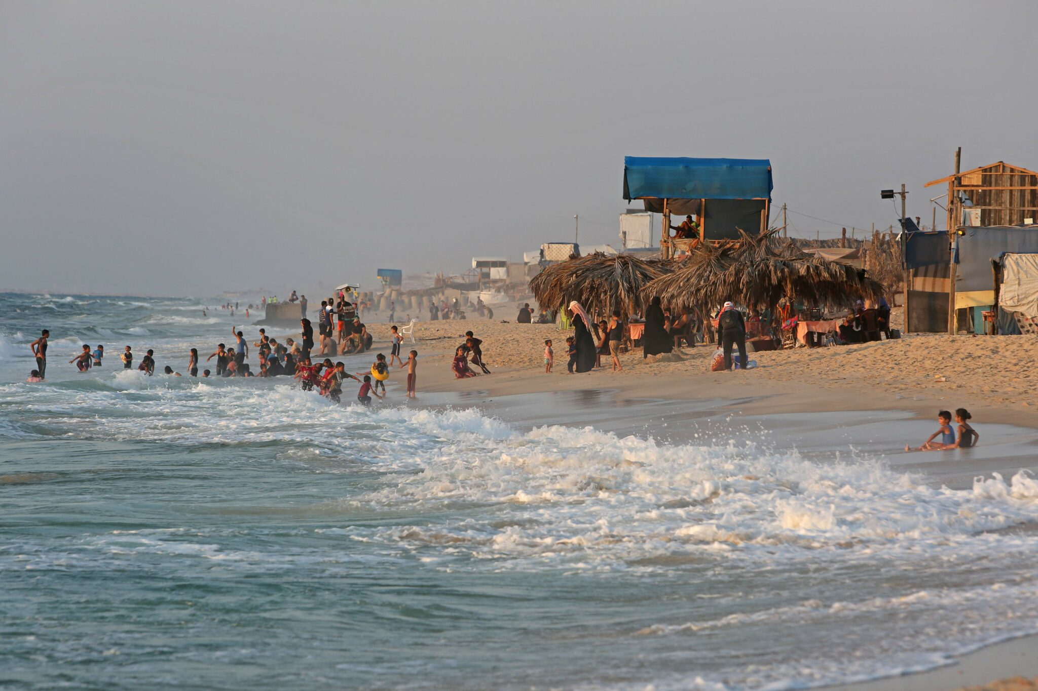 Palestinians gather at the beach in Rafah in the southern Gaza Strip on August 5, 2021. (Photo by SAID KHATIB / AFP)