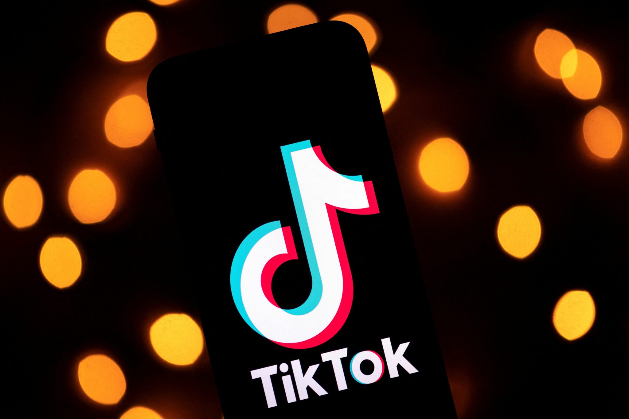 (FILES) This file photo taken on November 21, 2019 shows the logo of the social media video sharing app Tiktok displayed on a tablet screen in Paris. TikTok became the latest tech company on August 12, 2021 to announce tighter protections for teenagers as social media platforms come under increased scrutiny over their privacy safeguards.The short video-sharing app will roll out a number of features in the coming months, including a default curb for 16 and 17-year-olds on in-app messaging unless it is switched to a different setting. (Photo by Lionel BONAVENTURE / AFP)