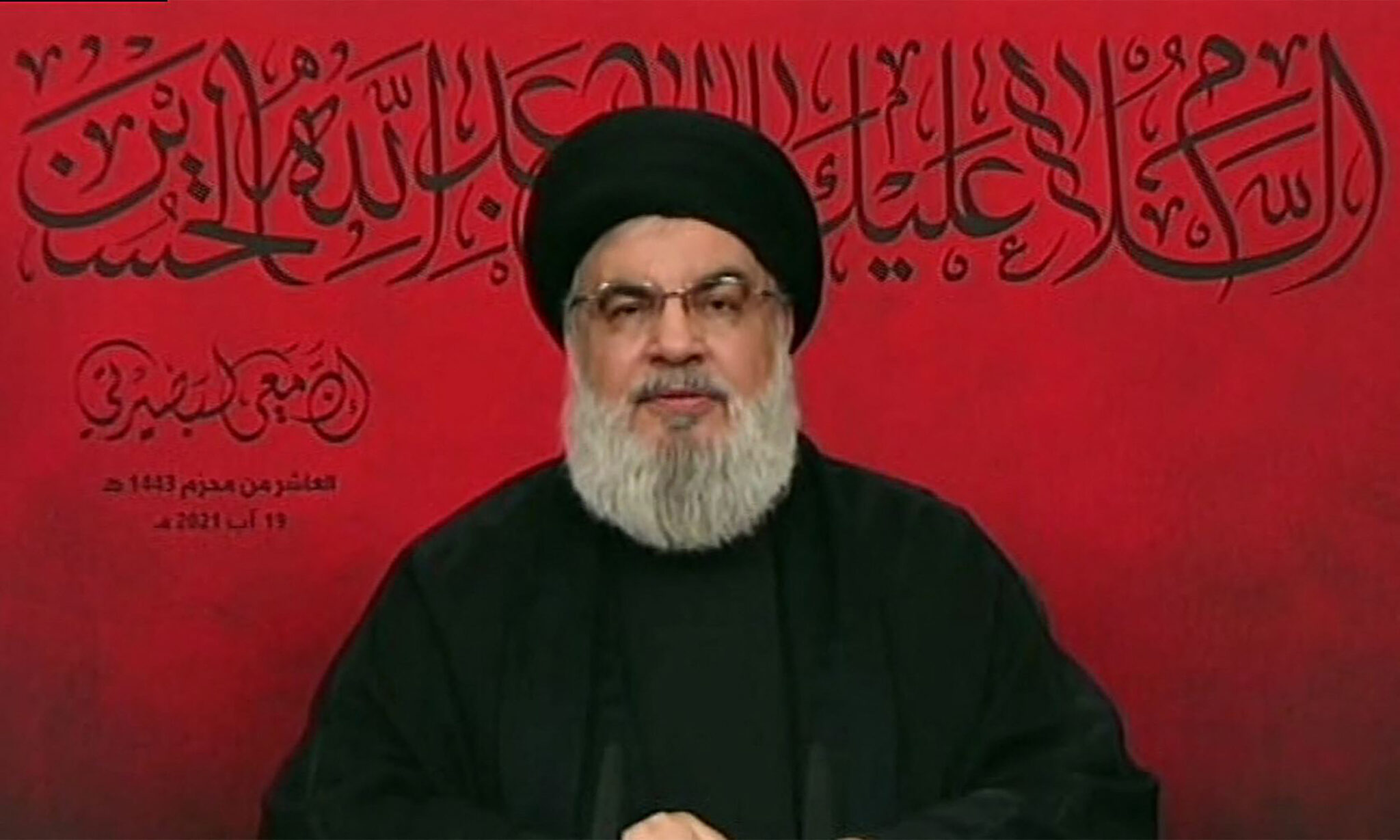 An image grab from Hezbollah's al-Manar TV on August 19, 2021, shows the head of the Lebanese Shiite movement Hezbollah Hassan Nasrallah, delivering a televised speech from an undisclosed location on the occasion of Ashura. Nasrallah vowed "suitable and proportionate" response to any Israeli air strike on Lebanon after a flare-up at the border this week, in a televised speech to mark the anniversary of the end of the last war with Israel in 2006. Israel carried out its first air raids on Lebanese soil in years on August 5, prompting Hezbollah to fire rockets back at the Jewish state the following day. - RESTRICTED TO EDITORIAL USE - MANDATORY CREDIT "AFP PHOTO / HO / AL-MANAR" - NO MARKETING NO ADVERTISING CAMPAIGNS - DISTRIBUTED AS A SERVICE TO CLIENTS (Photo by AL-MANAR / AFP) / RESTRICTED TO EDITORIAL USE - MANDATORY CREDIT "AFP PHOTO / HO / AL-MANAR" - NO MARKETING NO ADVERTISING CAMPAIGNS - DISTRIBUTED AS A SERVICE TO CLIENTS