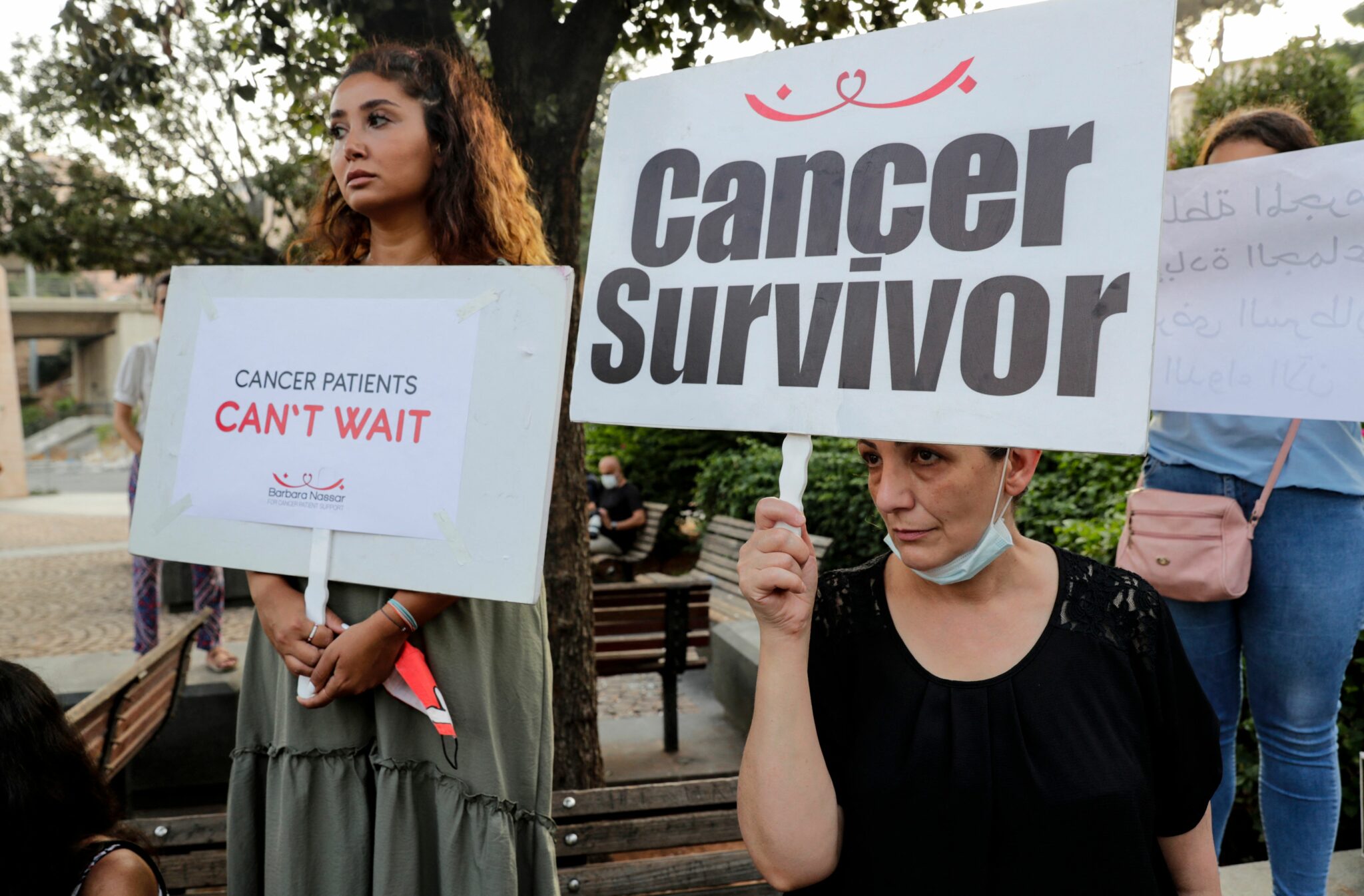 Demonstrators carry placards during a gathering by cancer patients to protest against the shortage of medicine that is threatening the treatment of tens of thousands of patients, outside the headquarters of the United Nations Economic and Social Commission for Western Asia (UN-ESCWA), in the centre of the capital Beirut on August 26, 2021. (Photo by ANWAR AMRO / AFP)