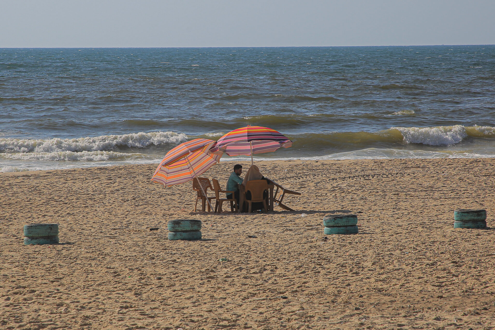 (210809) -- GAZA CITY, Aug. 9, 2021 (Xinhua) -- Palestinians enjoy their time at an eco-friendly cafe on the beach in Gaza city, July 28, 2021. TO GO WITH "Feature: Palestinians build eco-friendly cafe for awareness of waste recycling" (Photo by Rizek Abdeljawad/Xinhua)