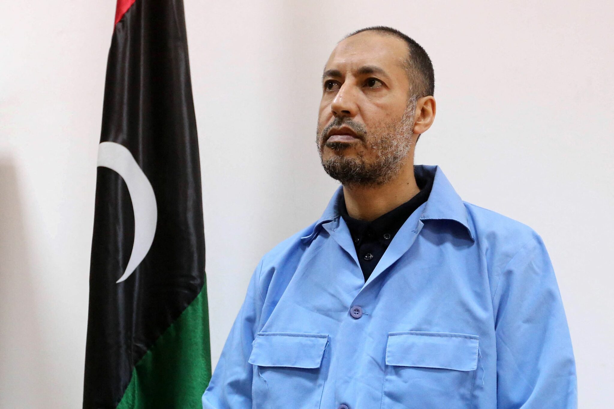 (FILES) In this file photo taken on March 13, 2016 Saadi Kadhafi, the son of slain Libyan dictator Moamer Kadhafi, sits waiting before trial at a courthouse in the Libyan capital Tripoli. Saadi Kadhafi, a son of Libya's late dictator Moamer Kadhafi who was overthrown and killed in a 2011 uprising, has been freed from jail, a justice ministry source confirmed. Several media reports on Sunday suggested Kadhafi had already taken a flight to Turkey. (Photo by MAHMUD TURKIA / AFP)