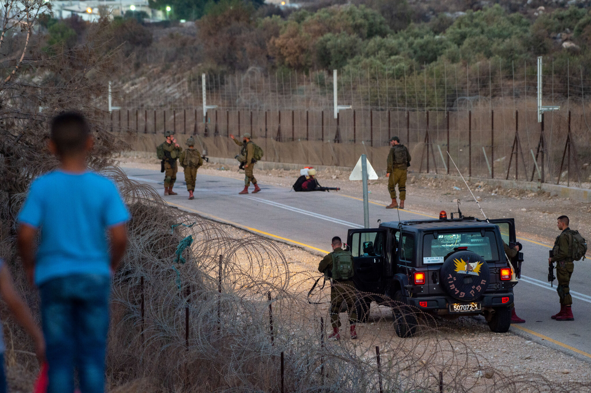 (210908) -- JENIN, Sept. 8, 2021 (Xinhua) -- Israeli soldiers guard the security fence near the West Bank city of Jenin, on Sept. 8, 2021. Israel's army said Wednesday it was extending the closure on the West Bank and Gaza due to a manhunt for six Palestinian escapees who tunneled their way out of jail on Monday. (Photo by Gil Eliyahu /JINI via Xinhua)