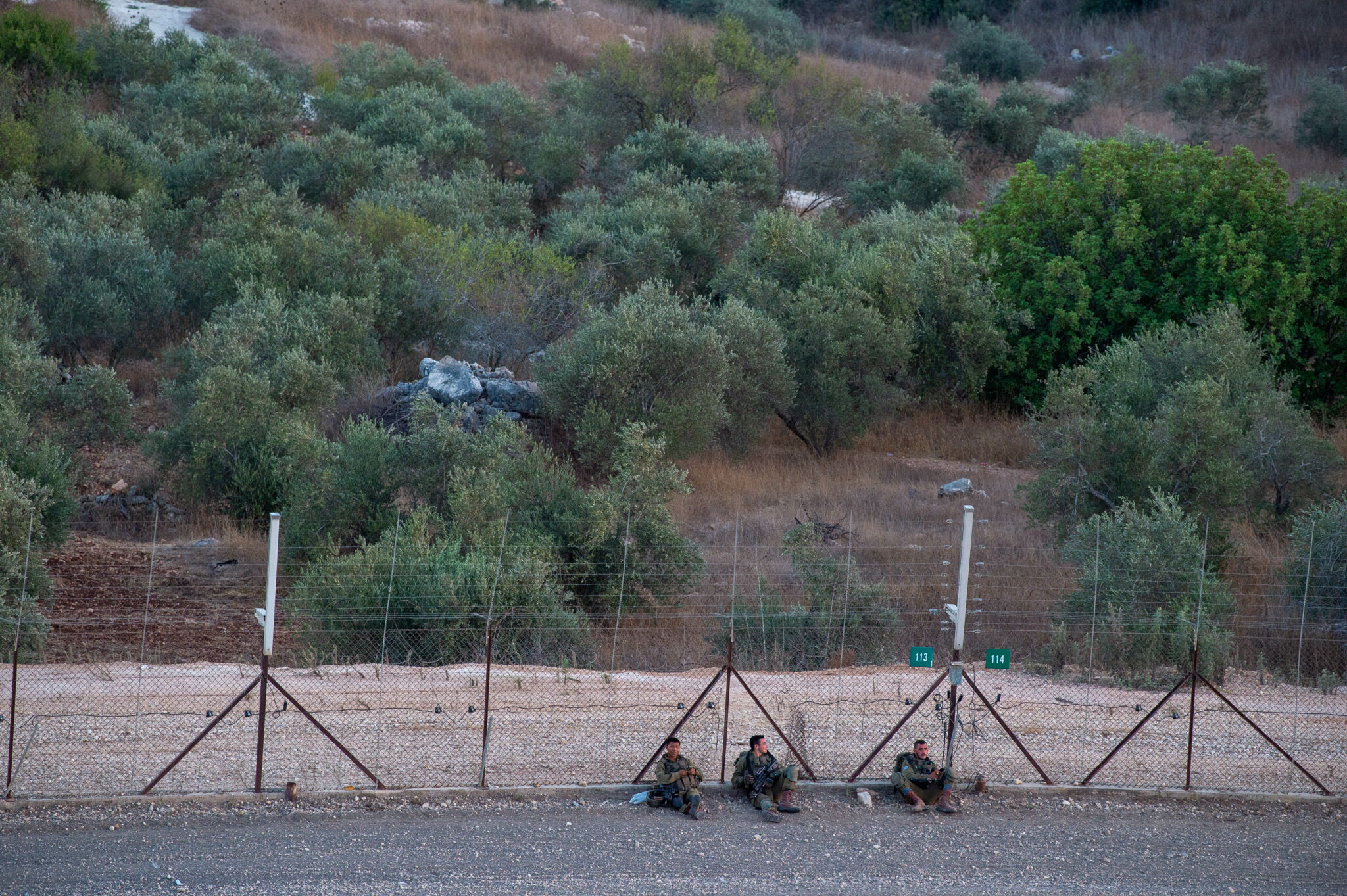 (210908) -- JENIN, Sept. 8, 2021 (Xinhua) -- Israeli soldiers guard the security fence near the West Bank city of Jenin, on Sept. 8, 2021. Israel's army said Wednesday it was extending the closure on the West Bank and Gaza due to a manhunt for six Palestinian escapees who tunneled their way out of jail on Monday. (Photo by Gil Eliyahu /JINI via Xinhua)