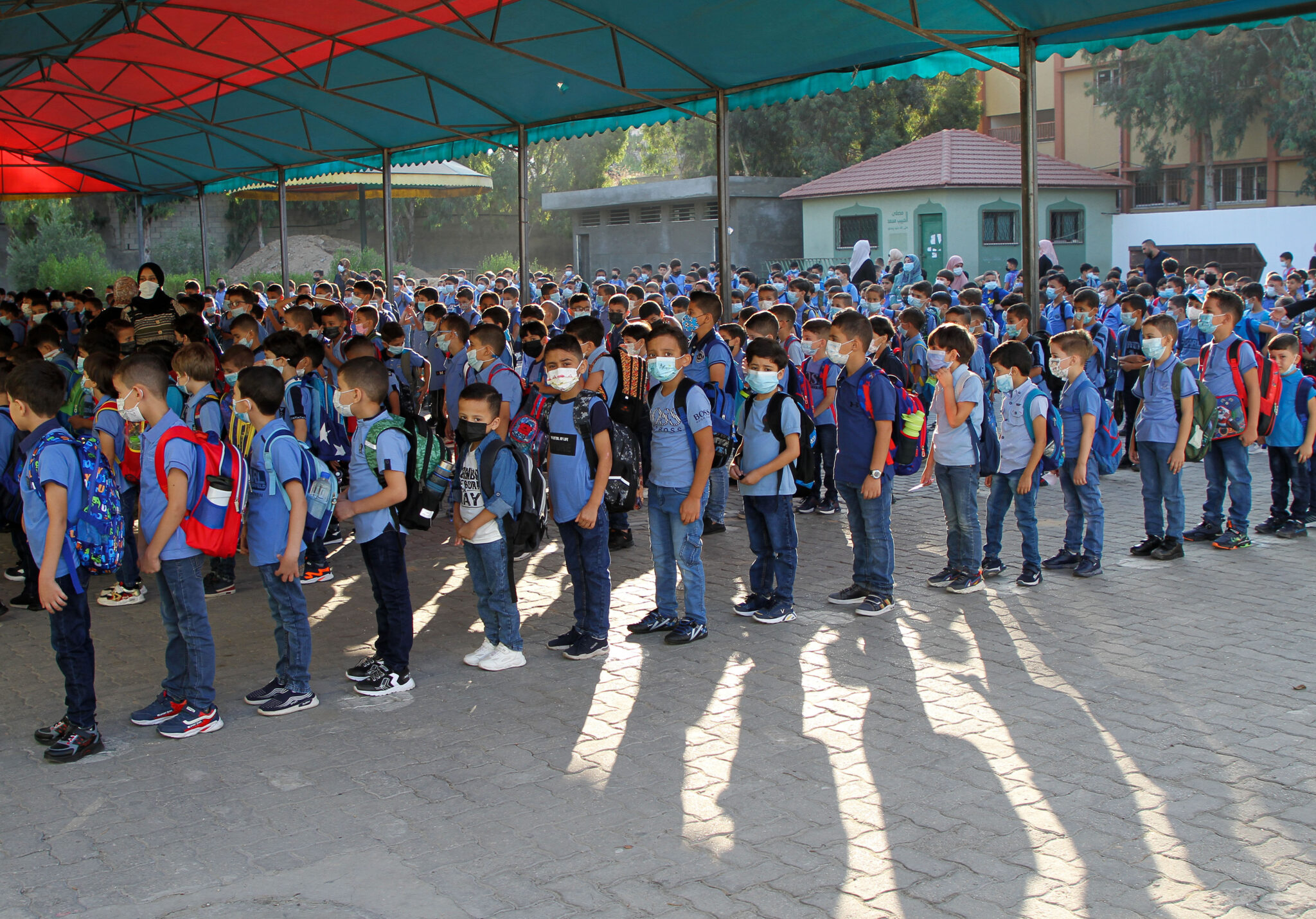 (210816) -- GAZA CITY, Aug. 16, 2021 (Xinhua) -- Students line up to attend school on the first day of the new school year in Gaza City, Aug. 16, 2021. More than a million students in the West Bank and the Gaza Strip have returned on Monday to their schools after several months of school closure due to the spread of the coronavirus.
TO GO WITH "Roundup: New school year starts in Palestinian territories after months of school closure" (Photo by Rizek Abdeljawad/Xinhua)