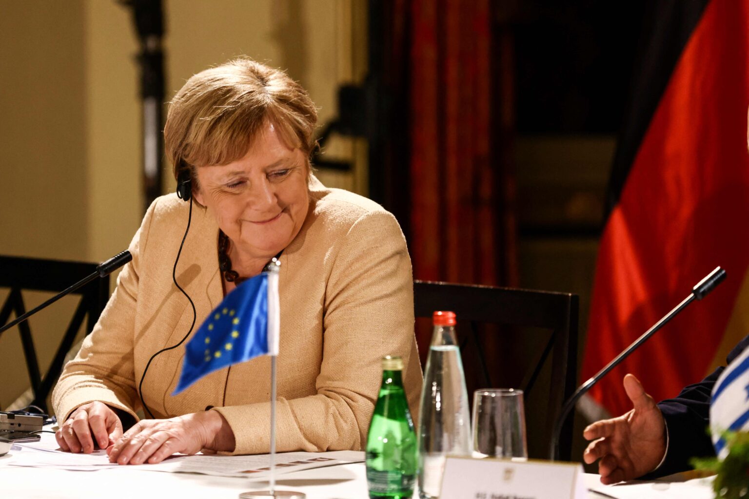 German Chancellor Angela Merkel and Israeli Prime Minister Naftali Bennett (unseen) chat during a roundtable discussion with Israeli entrepreneurs in Jerusalem October 10, 2021. (Photo by RONEN ZVULUN / POOL / AFP)