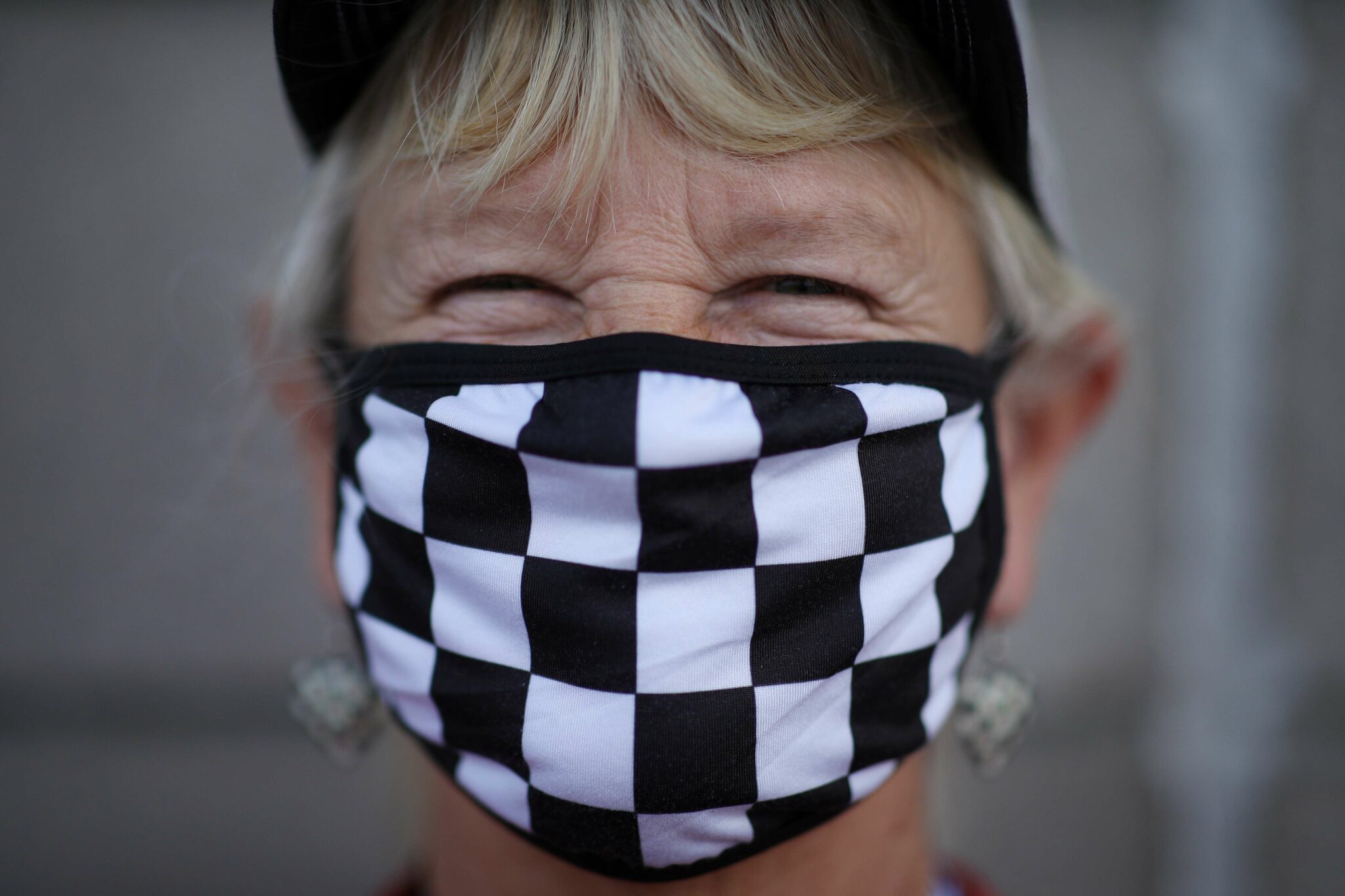 AVONDALE, ARIZONA - NOVEMBER 07: A masked NASCAR fan poses for photos prior to the NASCAR Cup Series Championship at Phoenix Raceway on November 07, 2021 in Avondale, Arizona. Sean Gardner/Getty Images/AFP == FOR NEWSPAPERS, INTERNET, TELCOS & TELEVISION USE ONLY ==