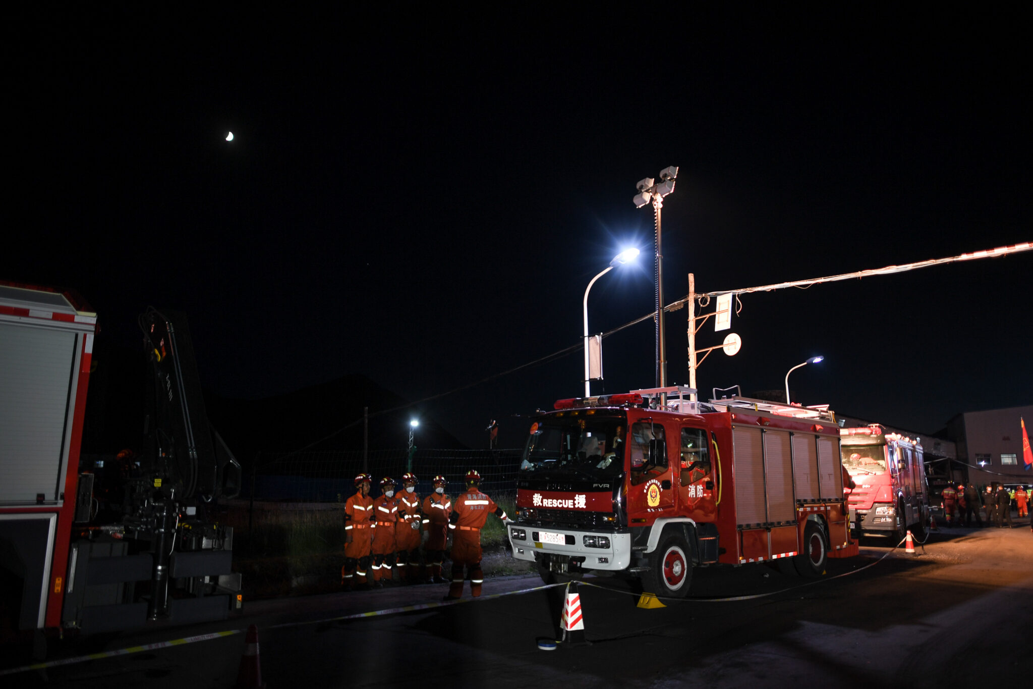 (210814) -- XINING, Aug. 14, 2021 (Xinhua) -- Rescue team members gather at the site of a coal mine accident in Haibei Tibetan Autonomous Prefecture, northwest China's Qinghai Province, Aug. 14, 2021. China's Ministry of Emergency Management has sent a work team to the northwest province of Qinghai to guide rescue efforts after a coal mine was flooded by mud on Saturday. Of the 21 miners working in the mine when the accident occurred, two were lifted to the ground, including one who was confirmed dead, while the rest remained trapped, according to the ministry. Rescue operations are underway as more rescuers rushed to the site. (Xinhua/Wu Gang)