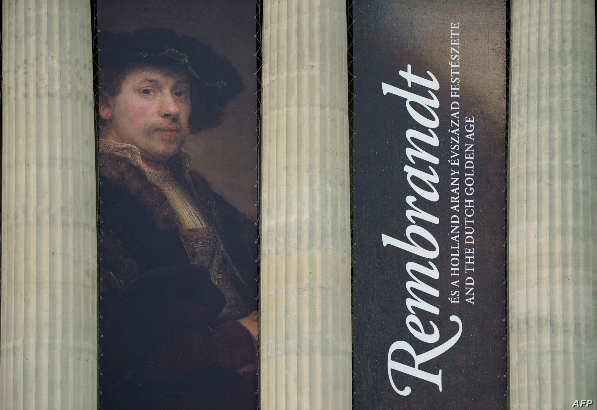 A giant reproduction hangs between colums of the Museum of Fine Arts in Budapest on October 30, 2014 during an exhibition of "Rembrandt and the Dutch Golden Age". From October 31, 2014 to February 15, 2015, the museum presents over 170 works by some 100 painters from the Dutch Golden Age. AFP PHOTO / ATTILA KISBENEDEK (Photo by ATTILA KISBENEDEK / AFP)