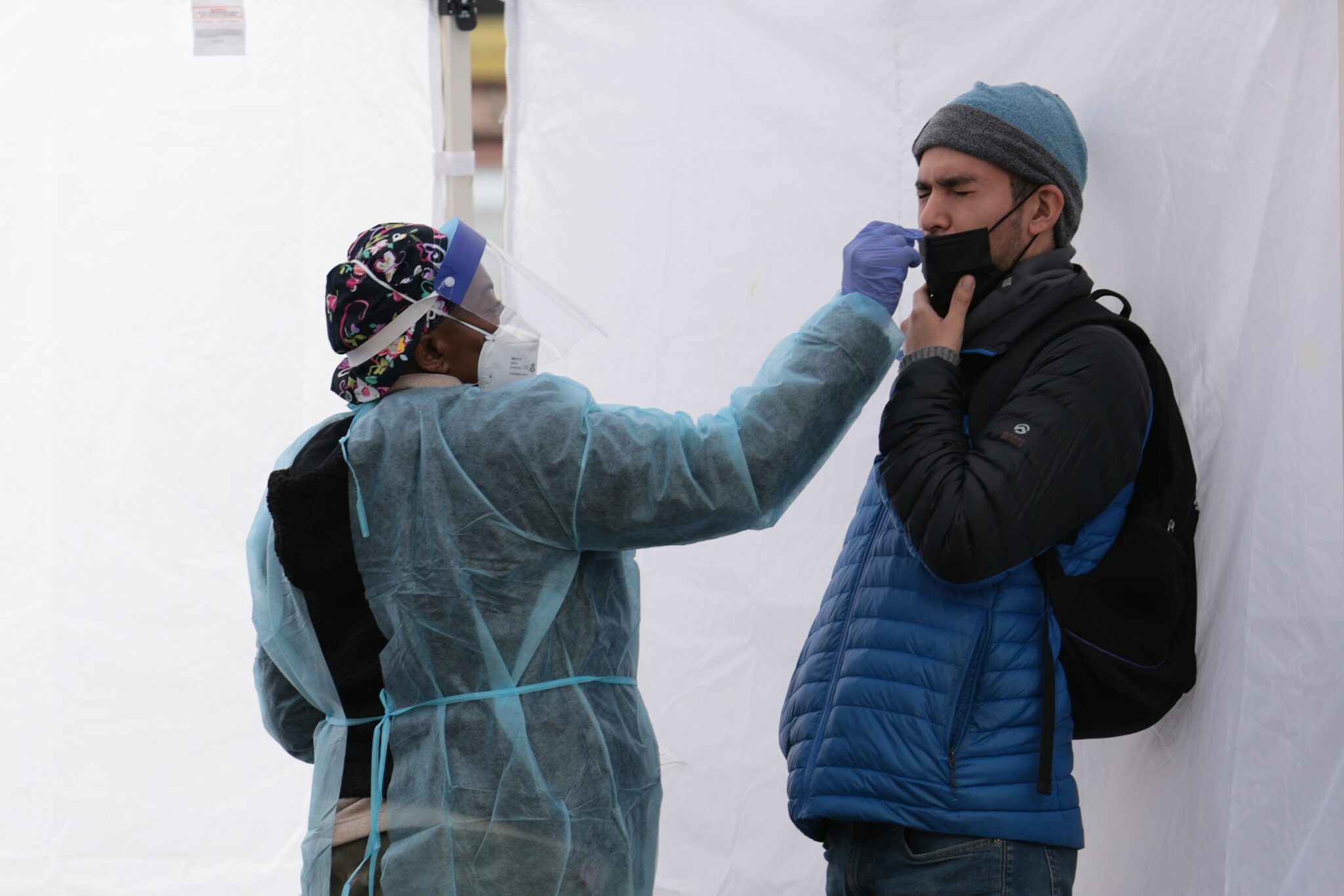 WASHINGTON, DC - DECEMBER 28: A healthcare worker administers a COVID-19 PCR test at a free test site in Farragut Square on December 28, 2021 in Washington, DC. Yesterday the CDC announced that people should self-isolate for five days, instead of ten, after they've tested positive for Covid-19 if they don't have symptoms. Anna Moneymaker/Getty Images/AFP == FOR NEWSPAPERS, INTERNET, TELCOS & TELEVISION USE ONLY ==