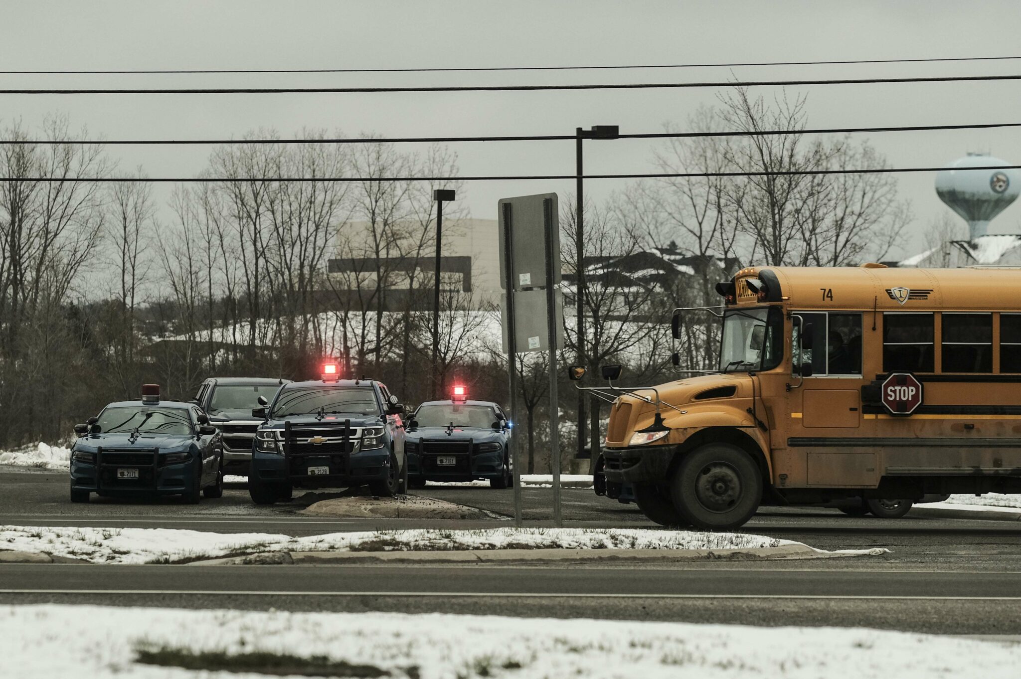 OXFORD, MI - NOVEMBER 30: Police cars restrict access to Oxford High School following a shooting on November 30, 2021 in Oxford, Michigan. According to reports, three people were killed and six others wounded by the alleged perpetrator, a 15 year old student who is now in police custody. Matthew Hatcher/Getty Images/AFP == FOR NEWSPAPERS, INTERNET, TELCOS & TELEVISION USE ONLY ==