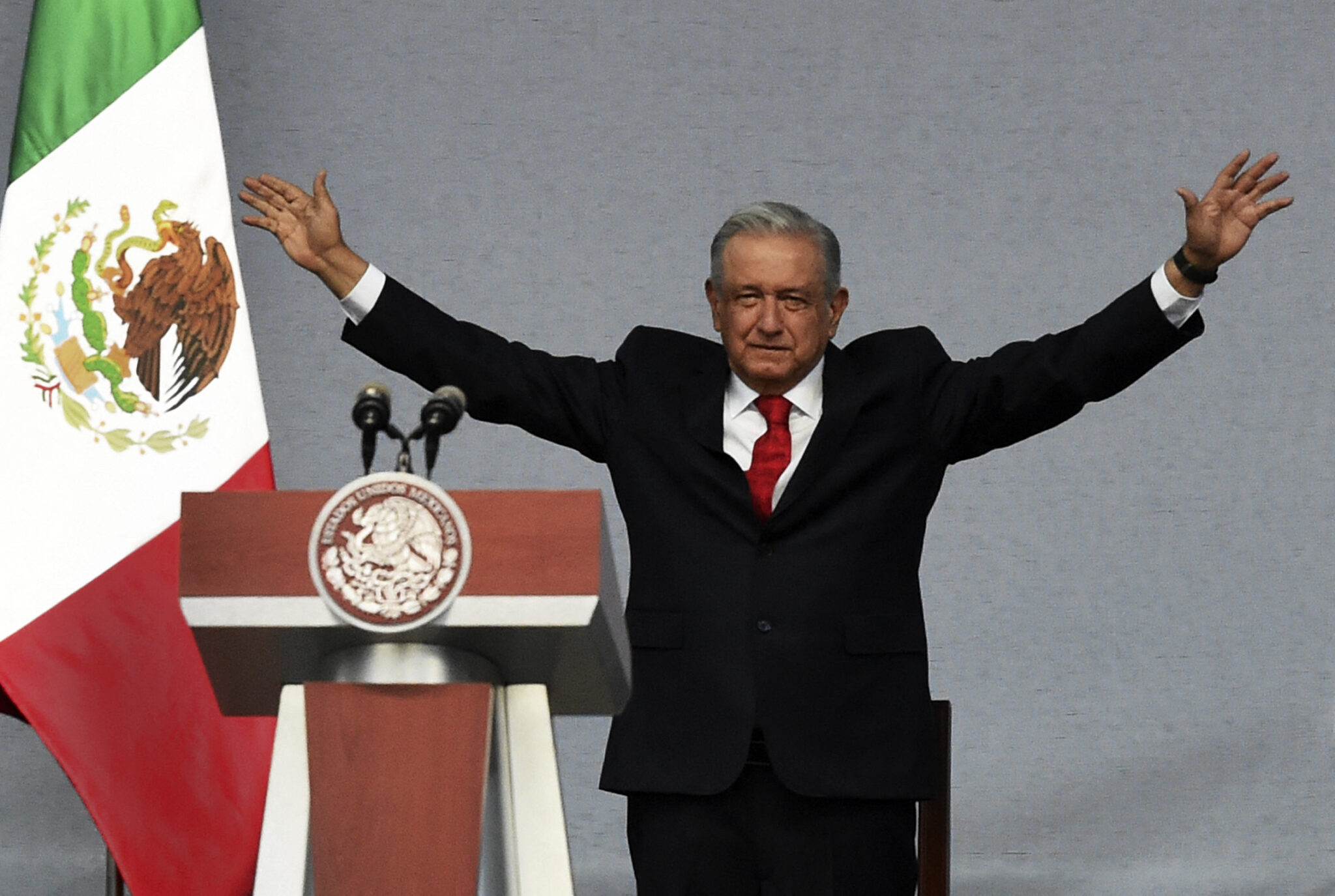 Mexican President Andres Manuel Lopez Obrador greets supporters, on arrival at Zocalo Square to deliver a Message to the Nation for his three years in power in Mexico City on December 1, 2021. (Photo by CLAUDIO CRUZ / AFP)