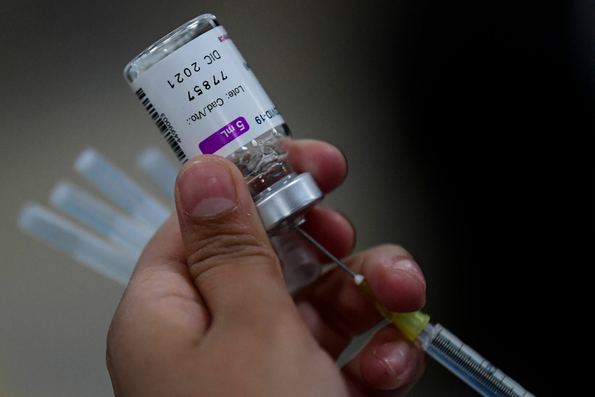 A nurse prepares a dose of the AstraZeneca vaccine against COVID-19 during the first day of the application of the third dose to people over 60 years-old at the Centro de Estudios Superiores Navales (CENCIS) in Mexico City, on December 7, 2021. (Photo by Pedro PARDO / AFP)