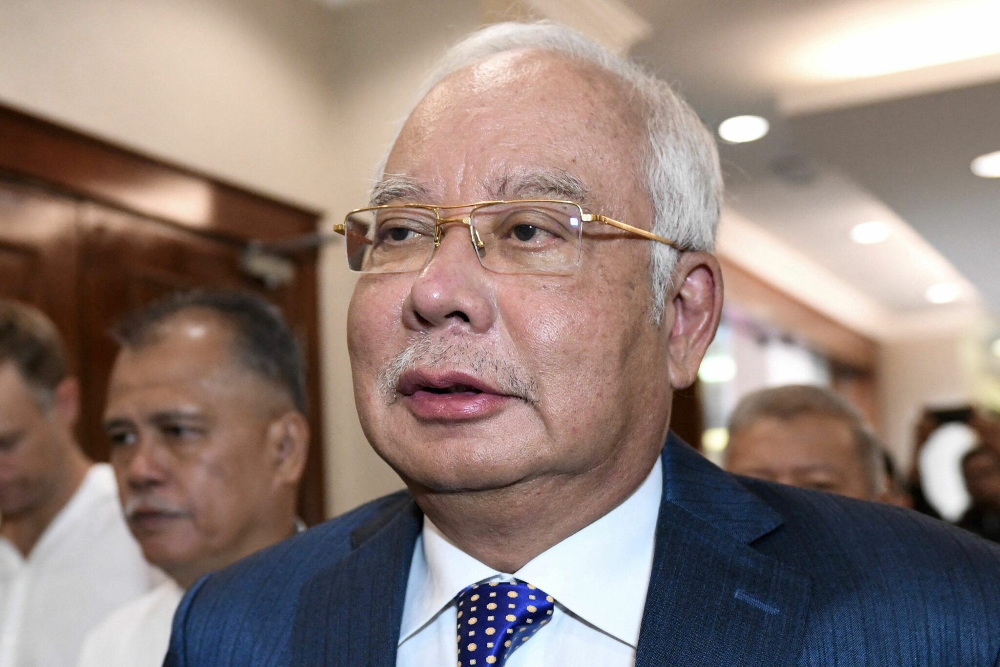 (FILES) This file photo taken on August 19, 2019 shows Malaysia's former prime minister Najib Razak arriving at the Kuala Lumpur High Court for his trial over 1MDB corruption allegations in Kuala Lumpur. A Malaysian appeal court on December 8, 2021 upheld former leader Najib Razak's conviction and 12-year jail term over the multi-billion-dollar 1MDB scandal, which contributed to his government's downfall in 2018. (Photo by Mohd RASFAN / AFP)