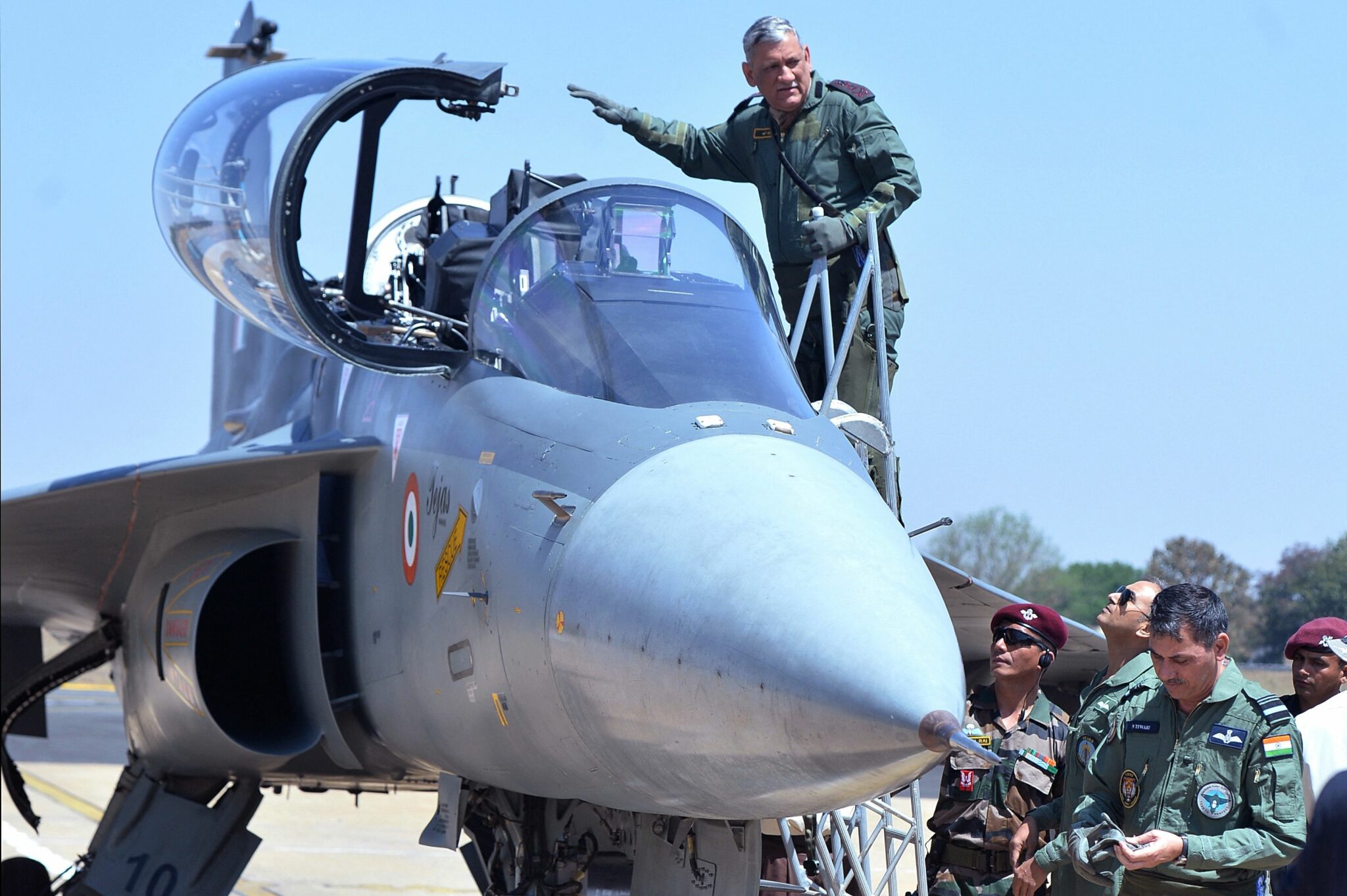 (FILES) In this file photo taken on February 21, 2019 the then 27th Chief of Army Staff Bipin Rawat waves as he boards in the co-pilot seat of a Light Combat Aircraft of the Indian Airforce during the Aero India airshow at the Yelahanka Air Force station in Bangalore. A helicopter carrying India's defence chief General Bipin Rawat crashed in the southern state of Tamil Nadu on December 8, 2021, the air force said. (Photo by Manjunath KIRAN / AFP)