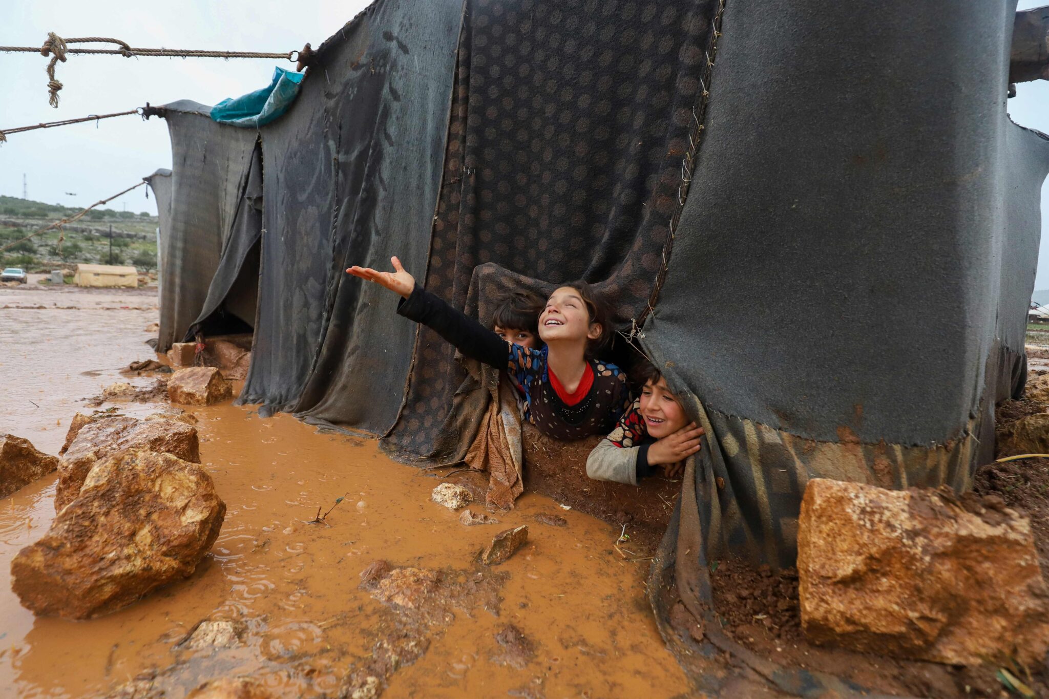 -- AFP PICTURES OF THE YEAR 2021 -- Children play play in the Umm Jurn camp for the displaced, near the village of Kafr Uruq, in Syria's northern rebel-held Idlib province, on January 17, 2021. - AFP PICTURES OF THE YEAR 2021 (Photo by Abdulaziz KETAZ / AFP) / AFP PICTURES OF THE YEAR 2021