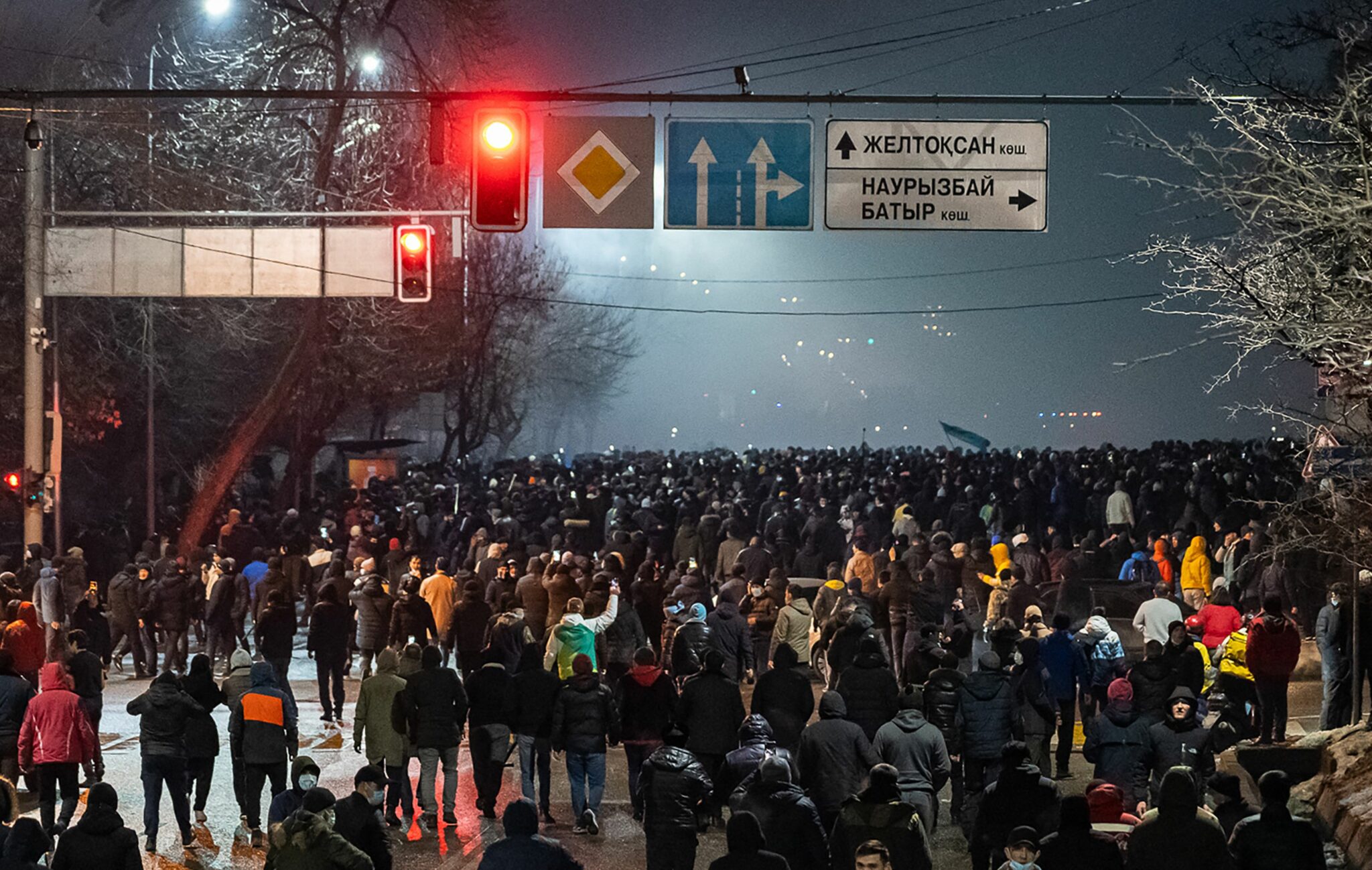 Protesters attend a rally in Almaty on January 4, 2022, after energy price hikes. Police fired tear gas and stun grenades in a bid to break up an unprecedented thousands-strong march in Almaty, Kazakhstan's largest city, after protests that began over fuel prices threatened to spiral out of control. (Photo by Ruslan PRYANIKOV / AFP)