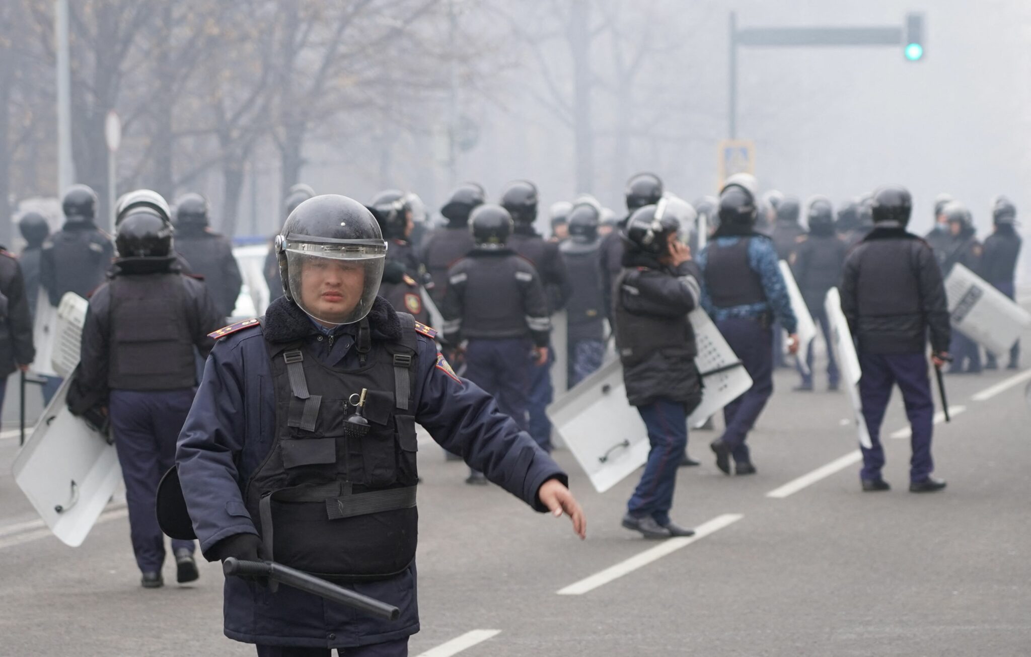 TOPSHOT - Riot police officers patrol in a street as unprecedented protests over a hike in energy prices spun out of control in Almaty on January 5, 2022. (Photo by Abduaziz MADYAROV / AFP)