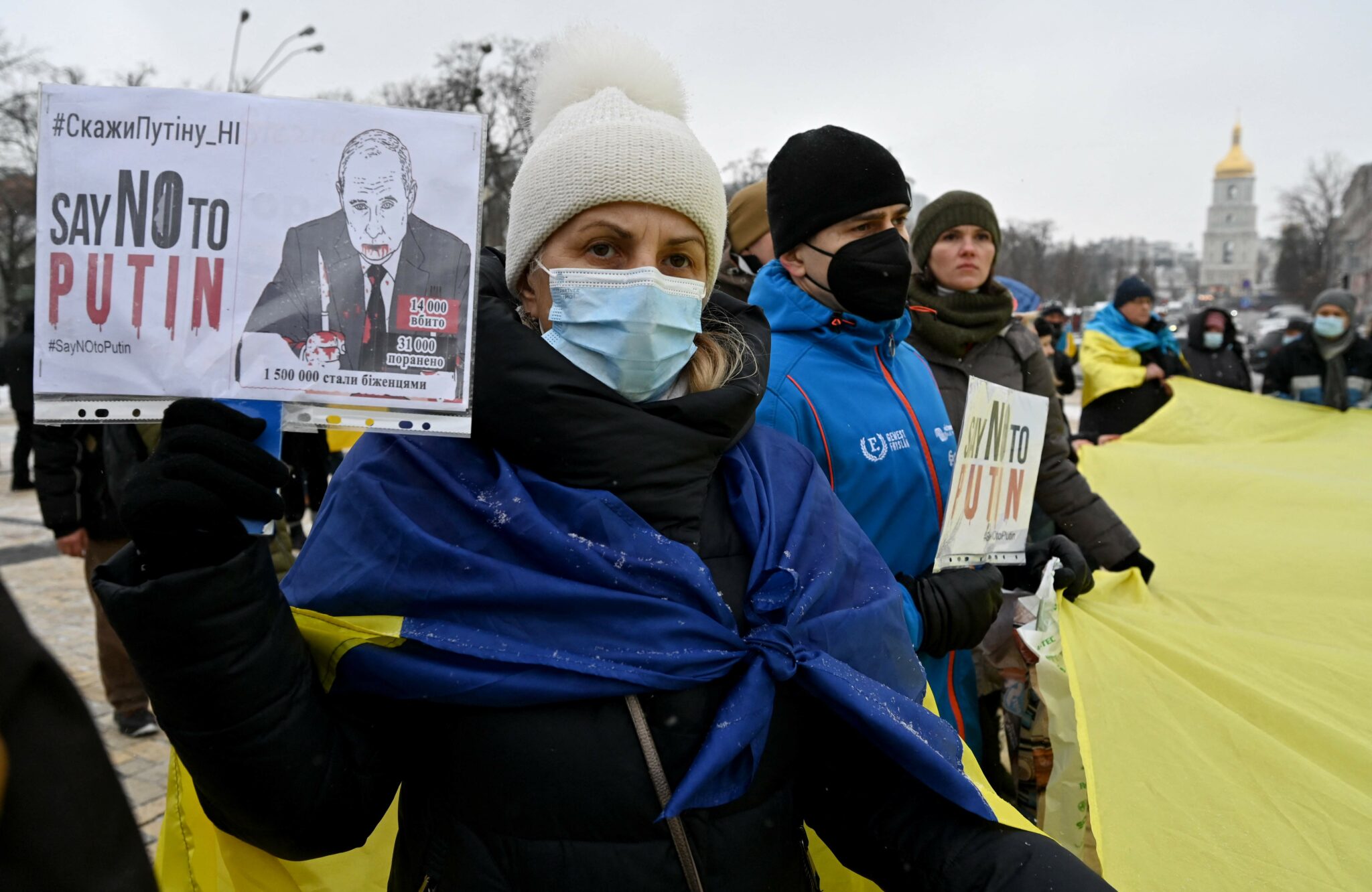 A demonstrator holds a placard during an action dubbed #SayNOtoPutin in Kiev on January 8, 2022. (Photo by Sergei SUPINSKY / AFP)