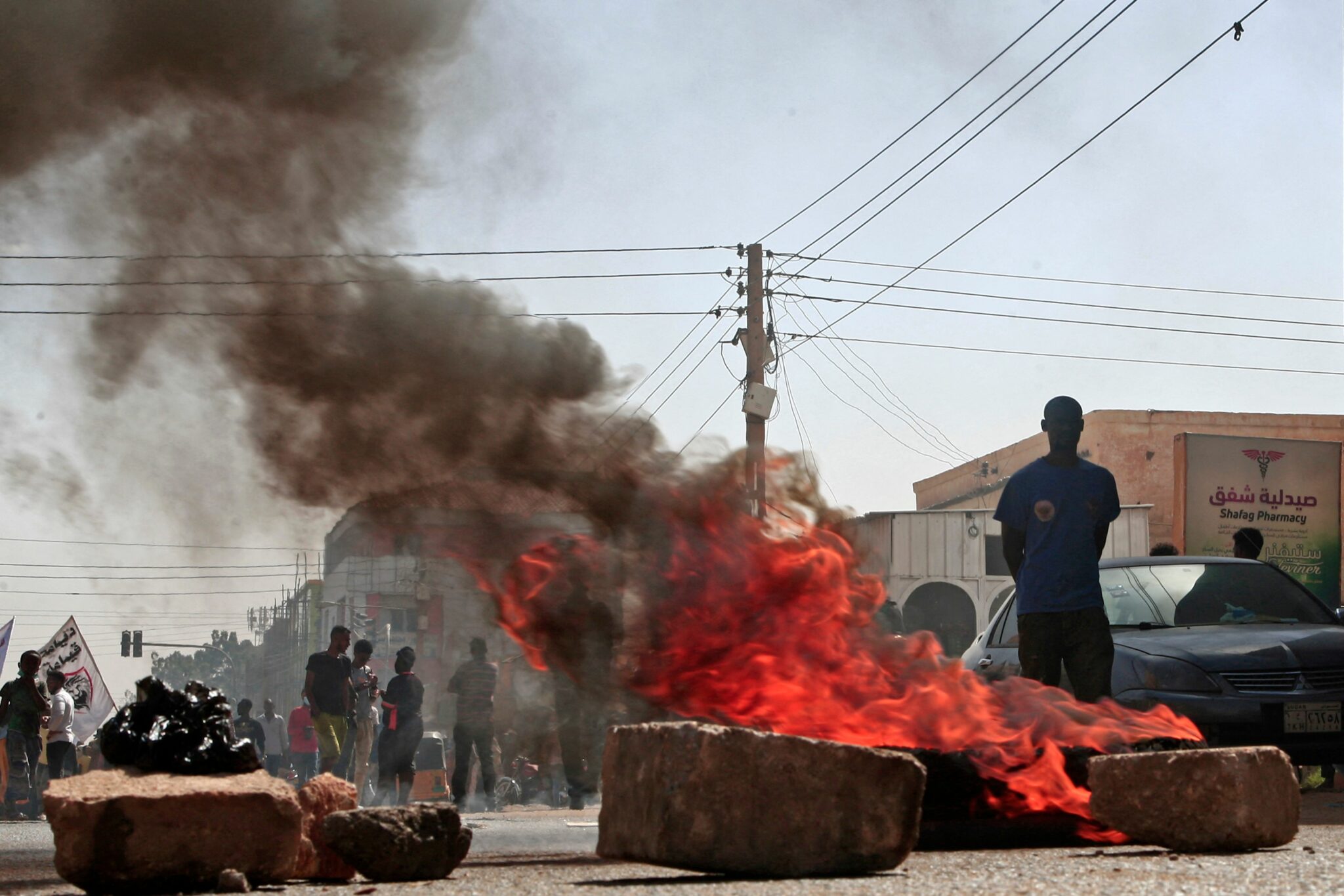 Sudanese rally against a military coup which occurred nearly three months ago, south of the capital Khartoum, on January 17, 2022. Thousands rallied again in Sudan to oppose a military coup which occurred nearly three months ago but security forces quickly fired tear gas towards them. (Photo by Ebrahim HAMID / AFP)