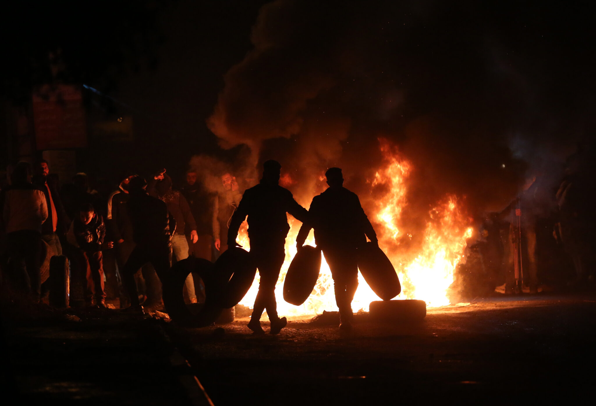 (220101) -- NABLUS, Jan. 1, 2022 (Xinhua) -- Palestinian protesters burn tires during clashes with Israeli soldiers in the village of Burqa, near the West Bank city of Nablus, on Jan. 1, 2022. (Photo by Ayman Nobani/Xinhua)