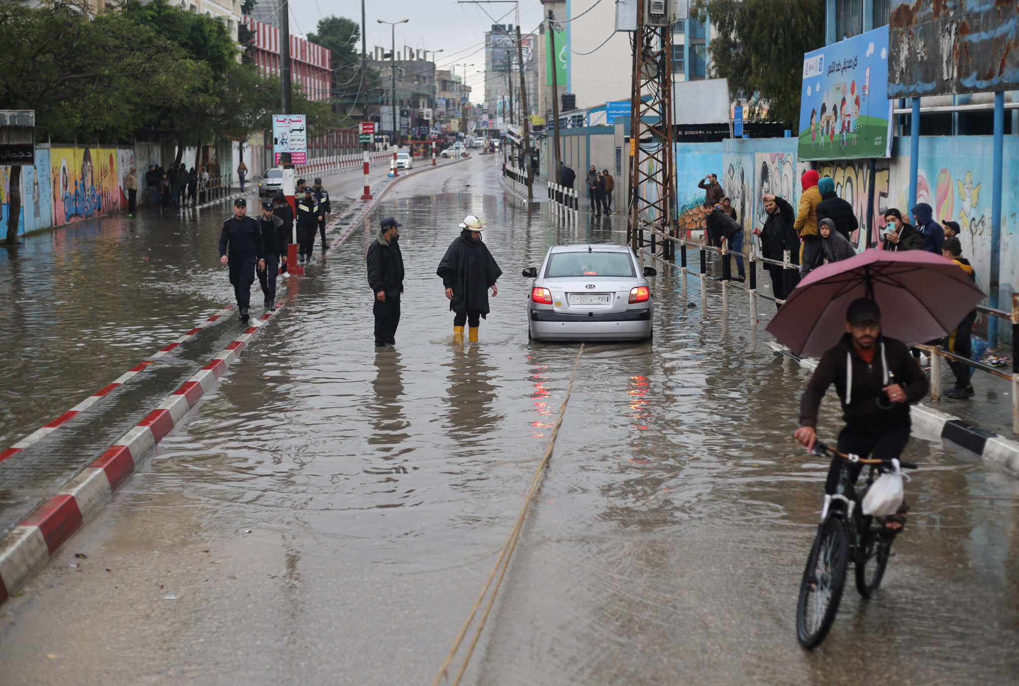 (220116) -- RAFAH, Jan. 16, 2022 (Xinhua) -- A car is stranded on a flooded street following heavy rain, in the southern Gaza Strip city of Rafah, on Jan. 16, 2022. (Photo by Khaled Omar/Xinhua)