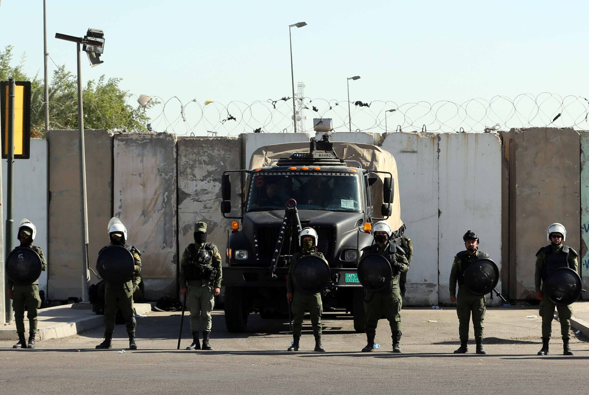 (211107) -- BAGHDAD, Nov. 7, 2021 (Xinhua) -- Members of the riot police stand in the vicinity of the Green Zone after a failed attempt to assassinate Iraqi Prime Minister Mustafa al-Kadhimi in Baghdad, Iraq, on Nov. 7, 2021. Iraqi Prime Minister Mustafa al-Kadhimi was unharmed in an assassination attempt carried out by a drone targeting his official residence on Sunday, the Iraqi military said. The media office of the Iraqi Joint Operations Command said in a statement that an unknown drone bomb hit al-Kadhimi's residency at dawn in the heavily fortified Green Zone in the center of the capital, but the prime minister escaped the attack unhurt. (Xinhua/Khalil Dawood)