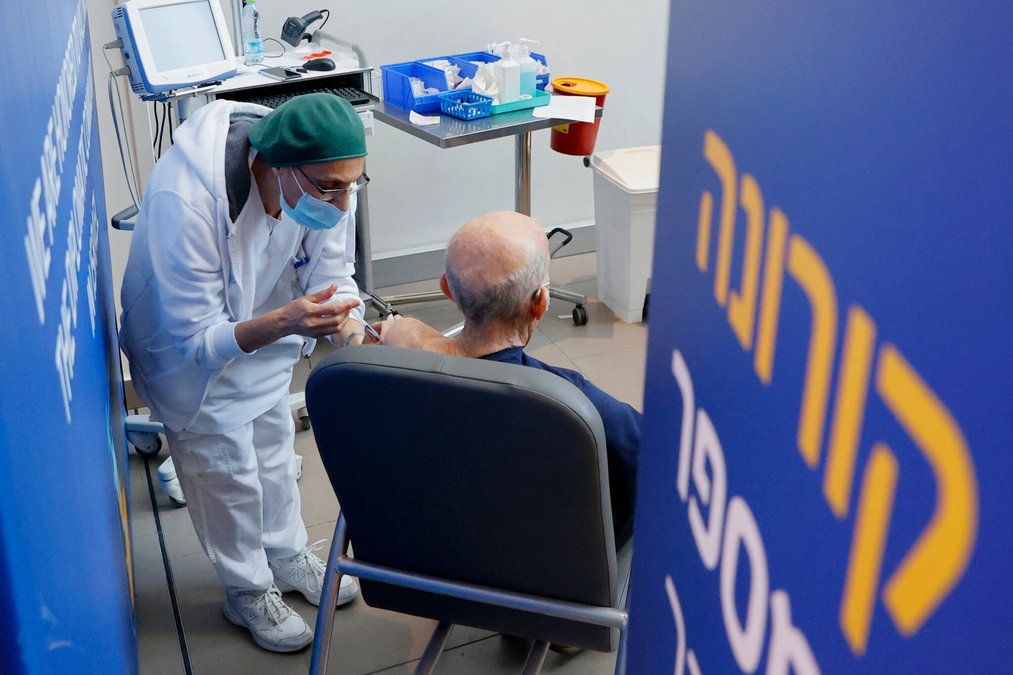 A person receives a fourth dose of the Pfizer-BioNTech COVID-19 coronavirus vaccine at Ichilov Tel Aviv Sourasky Medical Centre in Israel's Mediterranean coastal city of Tel Aviv on January 3, 2022. (Photo by JACK GUEZ / AFP)