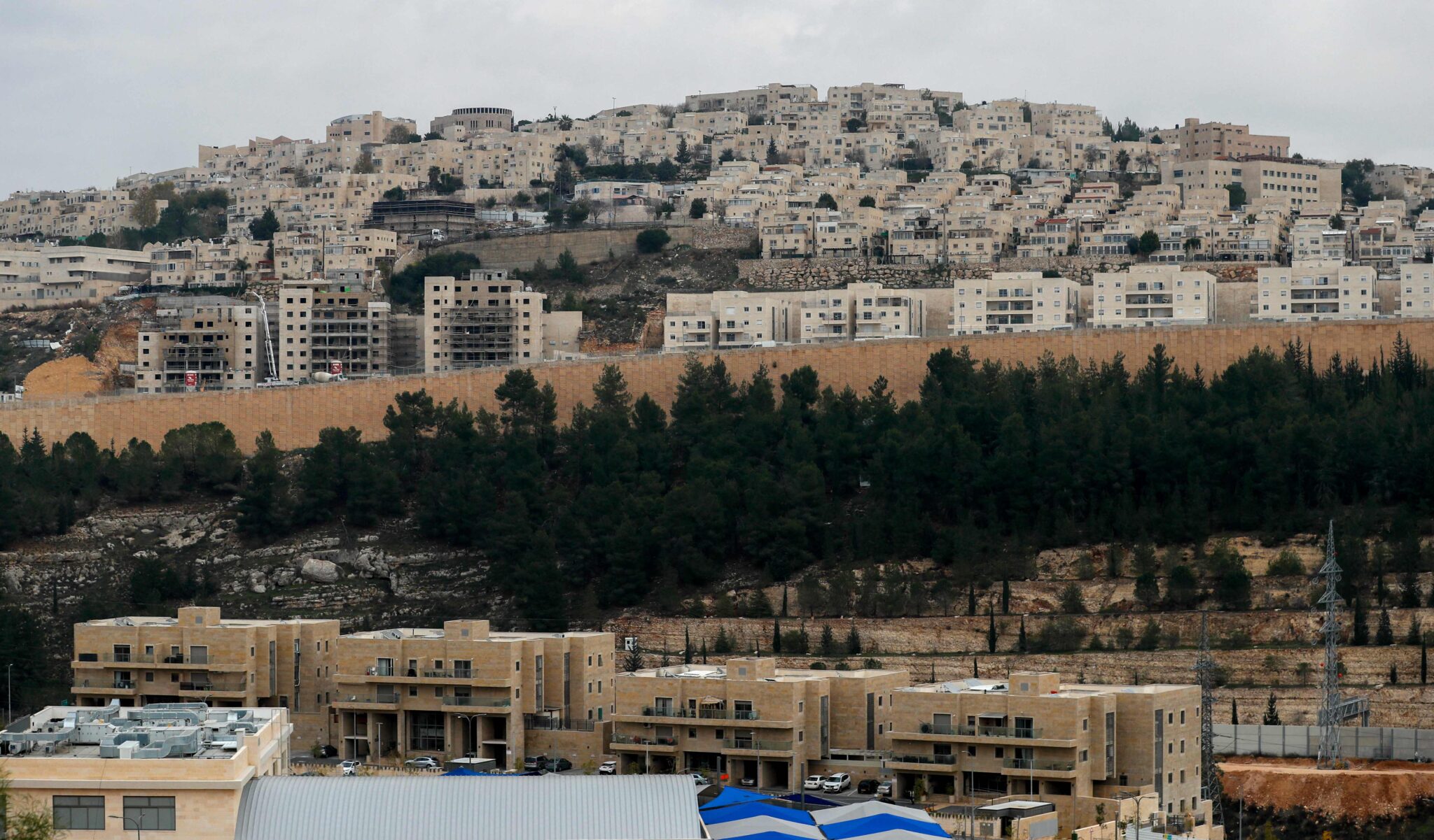 A general view shows ongoing construction work at Ramat Shlomo, a Jewish settlement in the Israeli-annexed eastern sector of Jerusalem, on January 5, 2022. (Photo by AHMAD GHARABLI / AFP)