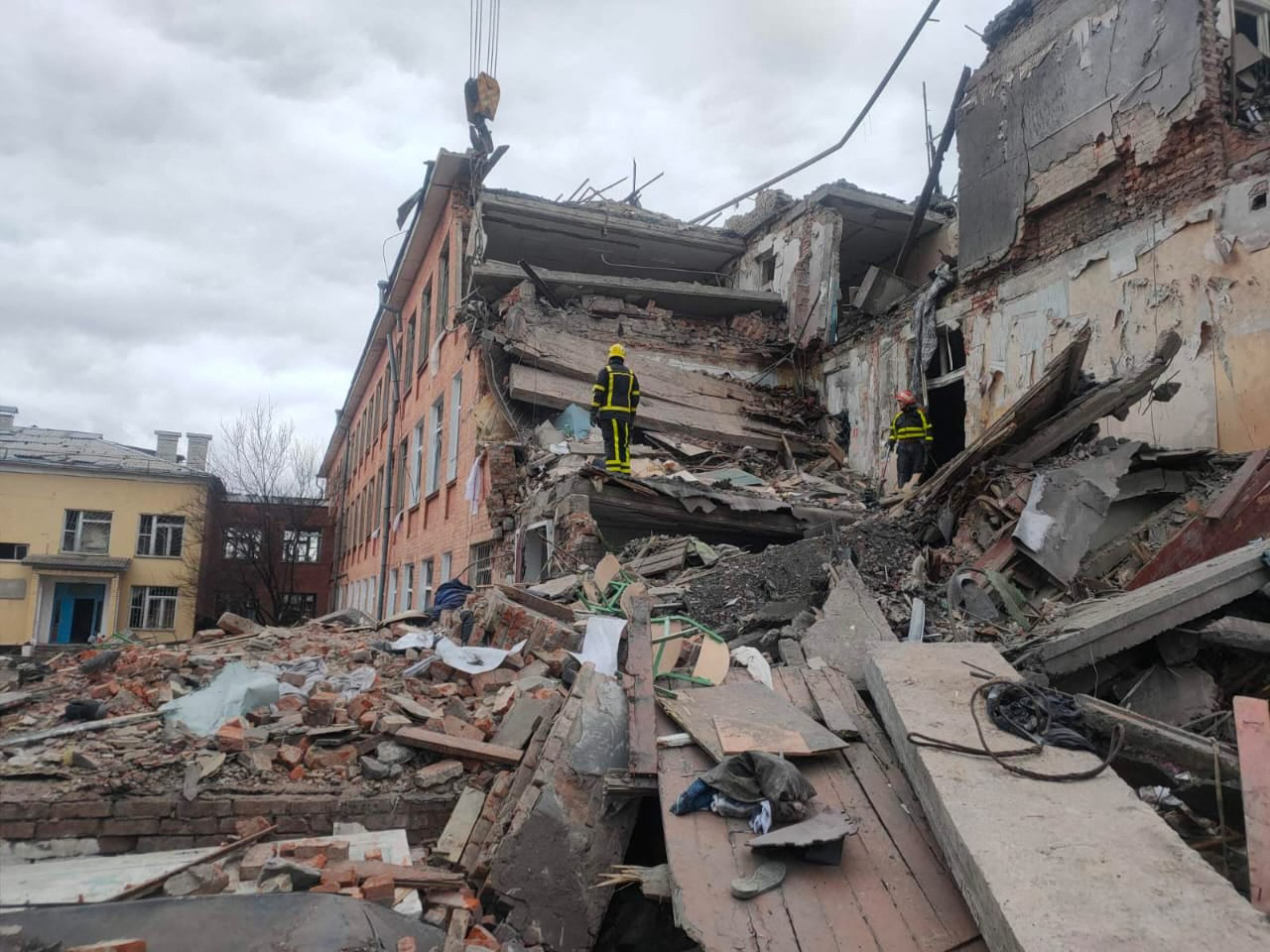 This handout picture taken and released by the Ukrainian State Emergency Service on March 7, 2022, shows rescuers dismantling the rubble of a destroyed school after Russian troops shelled the city of Chernihiv. Dozens of civilians are being killed in the battle for Chernihiv in the north. Some of those who remain are living in craters or among the ruins. - RESTRICTED TO EDITORIAL USE - MANDATORY CREDIT "AFP PHOTO / Ukrainian State Emergency Service" - NO MARKETING - NO ADVERTISING CAMPAIGNS - DISTRIBUTED AS A SERVICE TO CLIENTS (Photo by UKRAINIAN STATE EMERGENCY SERVICE / AFP) / RESTRICTED TO EDITORIAL USE - MANDATORY CREDIT "AFP PHOTO / Ukrainian State Emergency Service" - NO MARKETING - NO ADVERTISING CAMPAIGNS - DISTRIBUTED AS A SERVICE TO CLIENTS