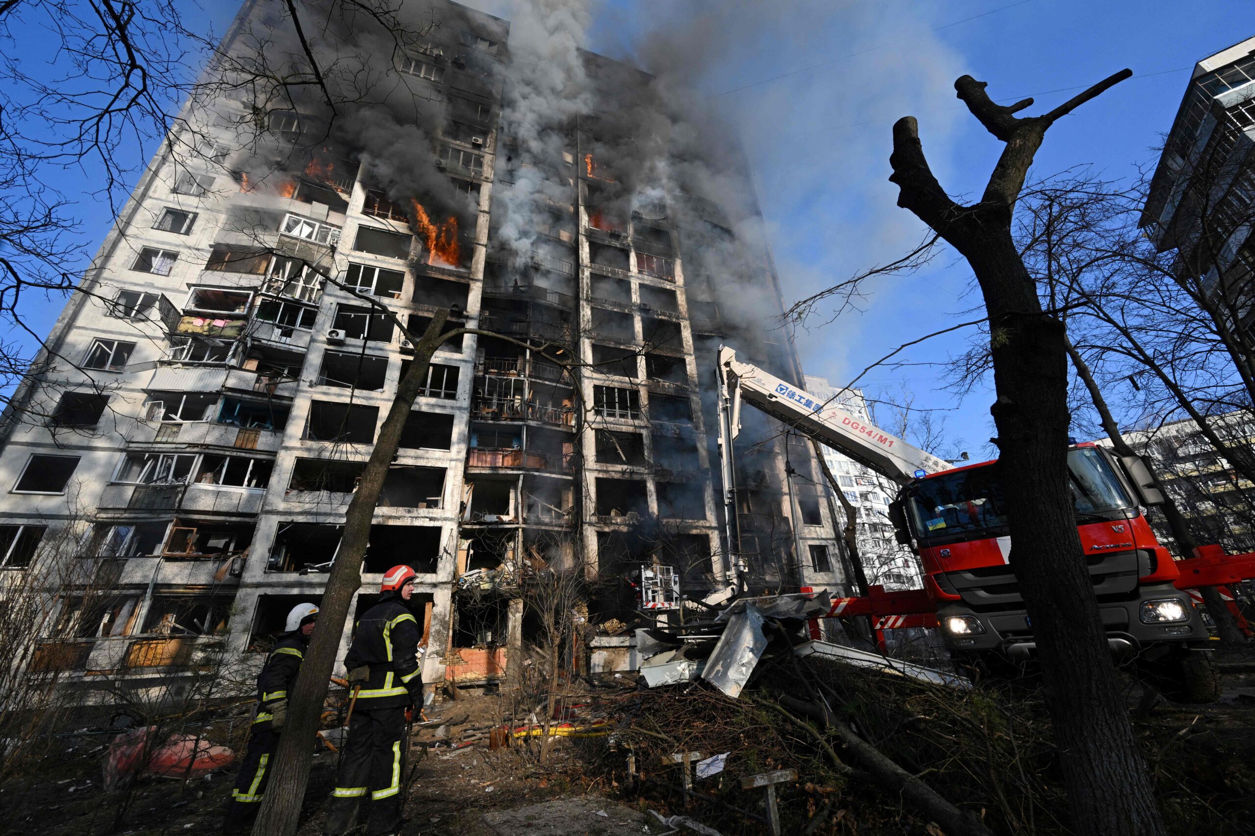 Firefighters extinguish a fire in a 16-storey residential building in Kyiv on March 15, 2022, after strikes on residential areas killed at least two people, Ukraine emergency services said as Russian troops intensified their attacks on the Ukrainian capital. A series of powerful explosions rocked residential districts of Kyiv early today killing two people, just hours before talks between Ukraine and Russia were set to resume. (Photo by Sergei SUPINSKY / AFP)