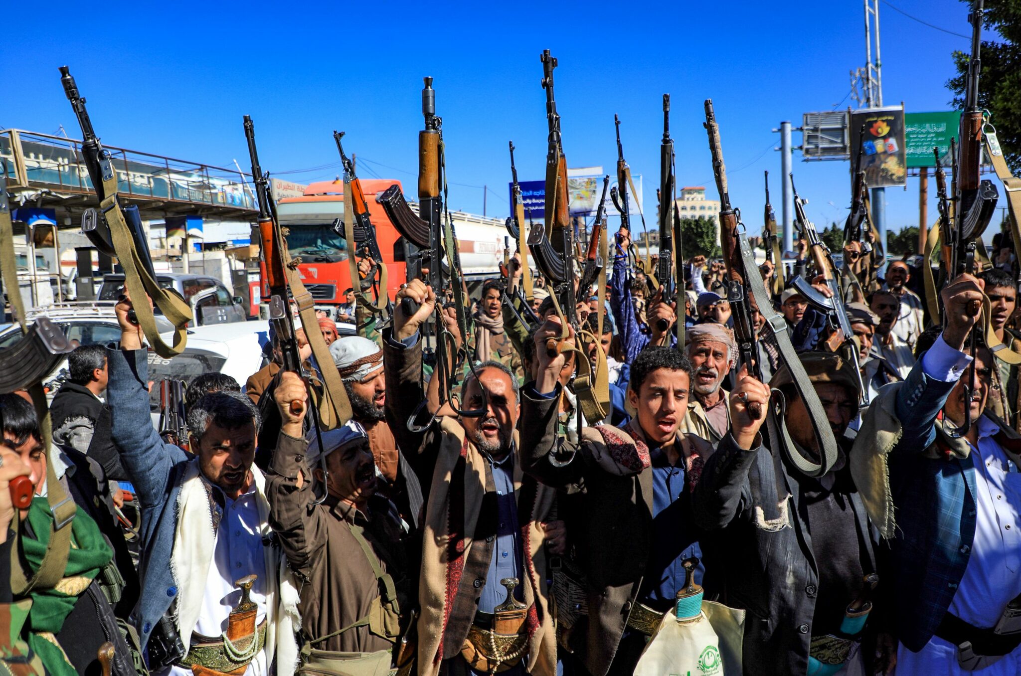 (FILES) In this file photo taken on January 27, 2022 Armed Yemeni supporters of the Iran-backed Huthi movement, brandish their weapons as they rally in the capital Sanaa to protest against the Saudi-led coalition's intervention in their country. The Saudi-led coalition backing the Yemeni government against Huthi rebels in Yemen's conflict announced on March 29 a halt to military operations during the Islamic fasting month of Ramadan from Wednesday morning. (Photo by MOHAMMED HUWAIS / AFP)