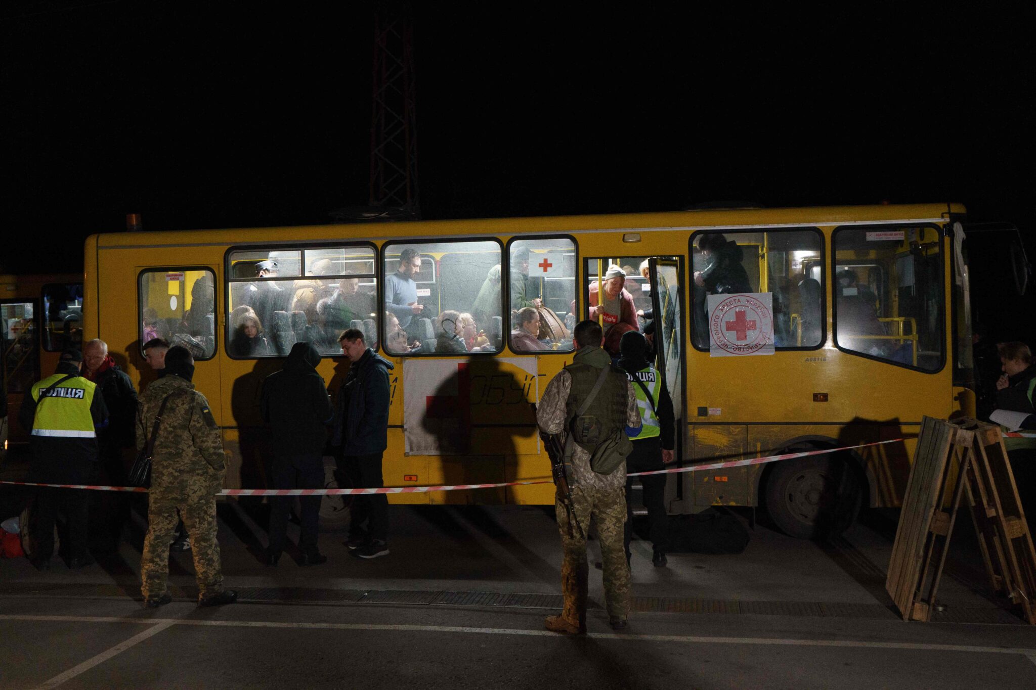 Passengers disembark as a convoy of 30 buses carrying evacuees from Mariupol and Melitopol arrive at the registration center in Zaporizhzhia, on April 1, 2022. Late on April 1, people who managed to flee Mariupol to Russian-occupied Berdiansk were from there carried on dozens of buses to Zaporizhzhia, some 200 kilometers (120 miles) to the northwest, according to an AFP reporter on the scene. (Photo by emre caylak / AFP)