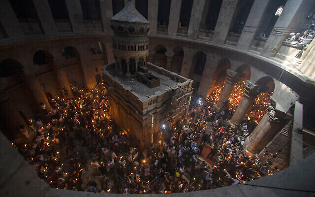 Christian pilgrims hold candles as they gather during the ceremony of the Holy Fire at Church of the Holy Sepulchre, where many Christians believe Jesus was crucified, buried and rose from the dead, in the Old City of Jerusalem, Saturday, May 1, 2021. Hundreds of Christian worshippers took use of Israel's easing of coronavirus restrictions Saturday and packed a Jerusalem church revered as the site of Jesus' crucifixion and resurrection for an ancient fire ceremony ahead of Orthodox Easter. (AP Photo/Ariel Schalit)