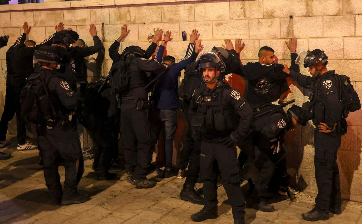 Israeli security forces detain men during clashes with Palestinians following the funeral of Walid al-Sharif, 23, who died of wounds suffered last month during clashes with Israeli police at Jerusalem's flashpoint al-Aqsa mosque compound, on May 16, 2022 outside the Old City of Jerusalem. Sharif, 23, was taken to Hadassah Ein Kerem hospital with a "head injury" on April 22 and he was "pronounced dead this morning", the hospital said in a statement. (Photo by AHMAD GHARABLI / AFP)