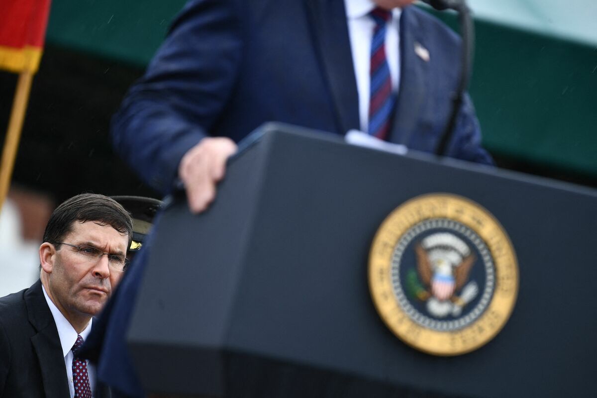 (FILES) In this file photo taken on September 30, 2019 US Secretary of Defense Mark Esper listens to US President Donald Trump during the Armed Forces Welcome Ceremony in honor of the Twentieth Chairman of the Joint Chiefs of Staff at Summerall Field, Joint Base Myer-Henderson Hall, Virginia. Donald Trump asked about the possibility of bombing drug trafficking labs in Mexico while he was US president, former defense secretary Mark Esper says in a book set to be released May 10, 2022. According to excerpts cited by the New York Times ON mAY 5, 2022, Trump believed the United States could pretend it wasn't responsible for launching missiles across its southern border, Esper, who was Pentagon head between July 2019 and November 2020, writes. (Photo by Brendan Smialowski / AFP)