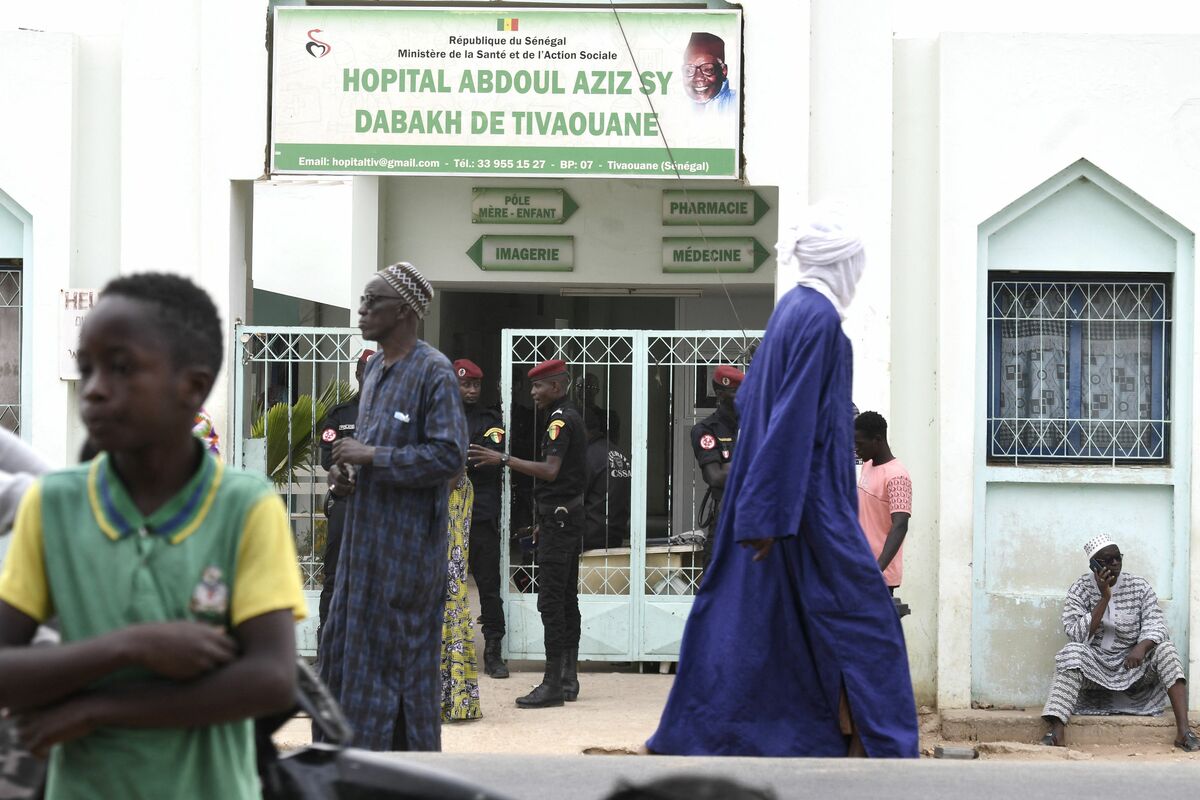 Visitors stand in front of the Mame Abdoul Aziz Sy Dabakh Hospital, where eleven babies died following an electrical fault, in Tivaouane, on May 26, 2022. Eleven newborn babies died in a hospital fire in the western Senegalese city of Tivaouane, the president of the country said late May 25, 2022. (Photo by SEYLLOU / AFP)