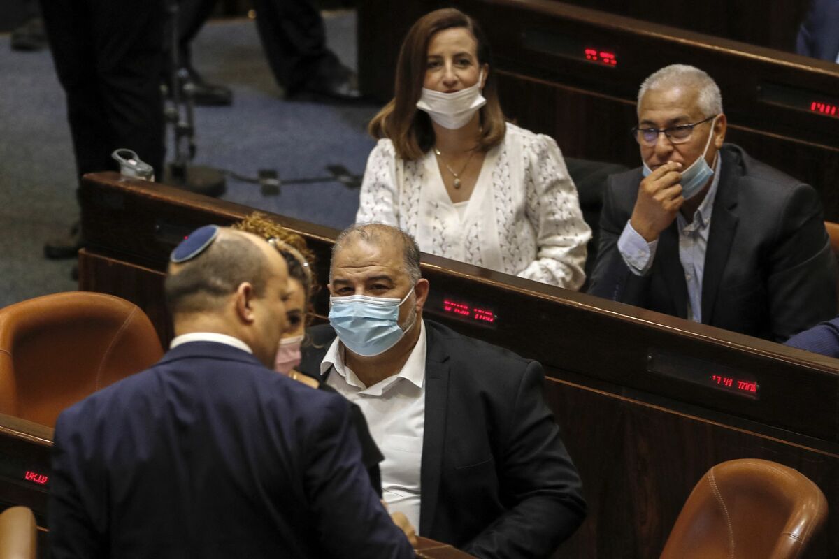 Ghaida Rinawie Zoabi (top), an Arab-Israeli lawmaker and member of the dovish Meretz party, attends a session in the Knesset (Israeli parliament), in Jerusalem on November 3, 2021. Zoabi, who quit the governing coalition in May 2022, citing grievances including police aggression at an Al Jazeera reporter's funeral, reversed her decision on May 22. (Photo by AHMAD GHARABLI / AFP)